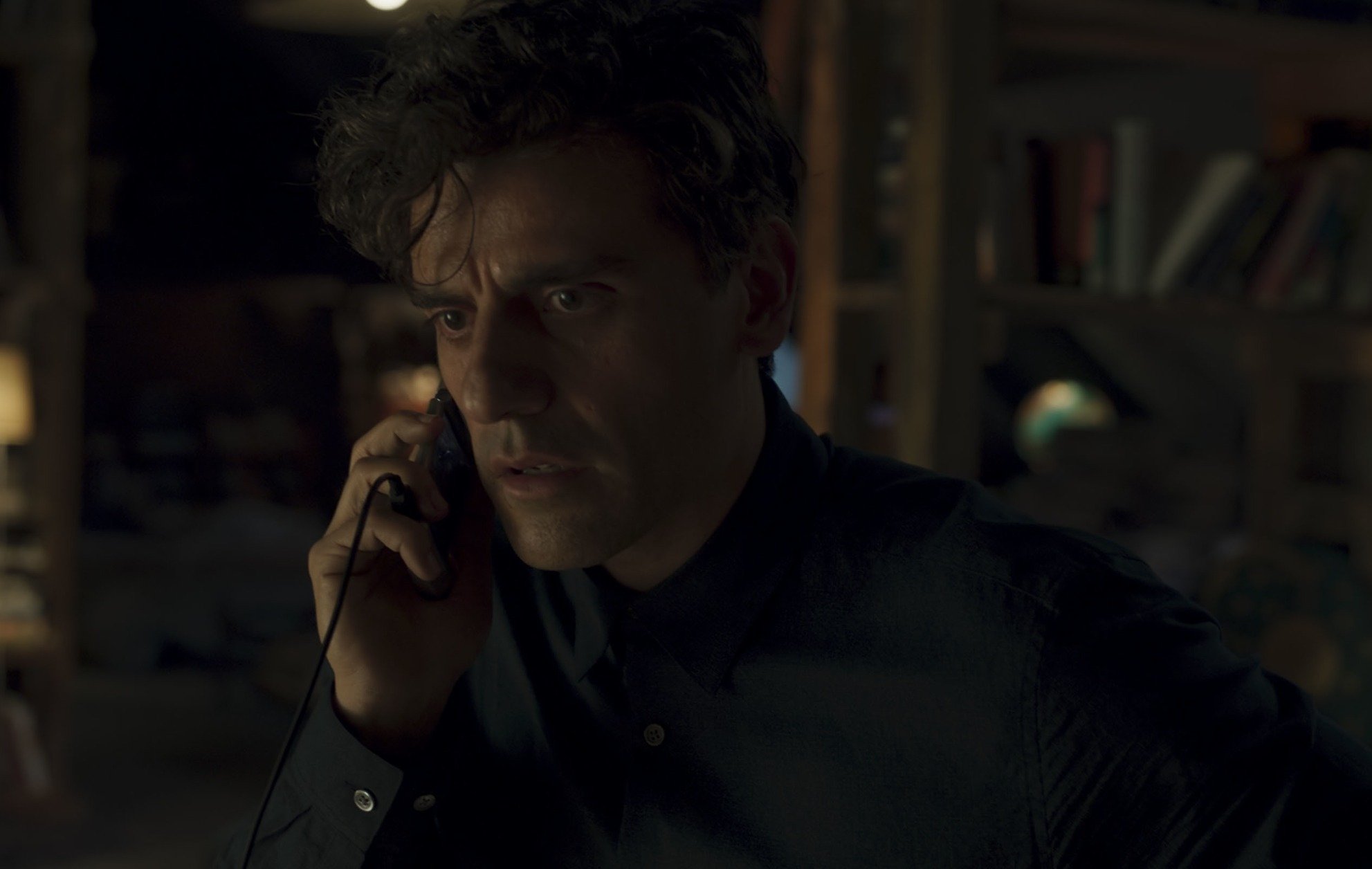 Oscar Isaac as Steven Grant in 'Moon Knight' Episode 1 on Disney+. He's talking on the phone and looks confused.