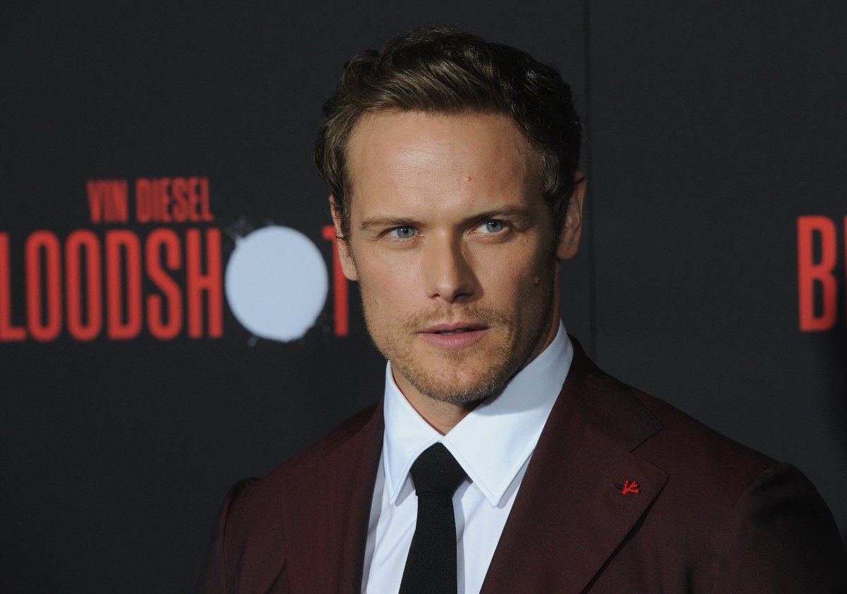 Outlander Sam Heughan wearing a burgundy suit and a perfect smize arrives for the Premiere Of Sony Pictures' "Bloodshot" held at The Regency Village on March 10, 2020