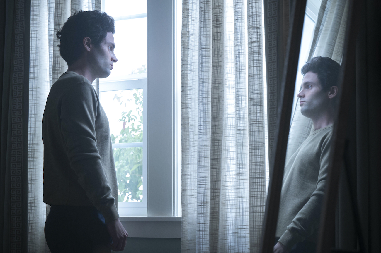 Joe Goldberg (Penn Badgley) looks at his reflection in the mirror in season 3 of 'You'