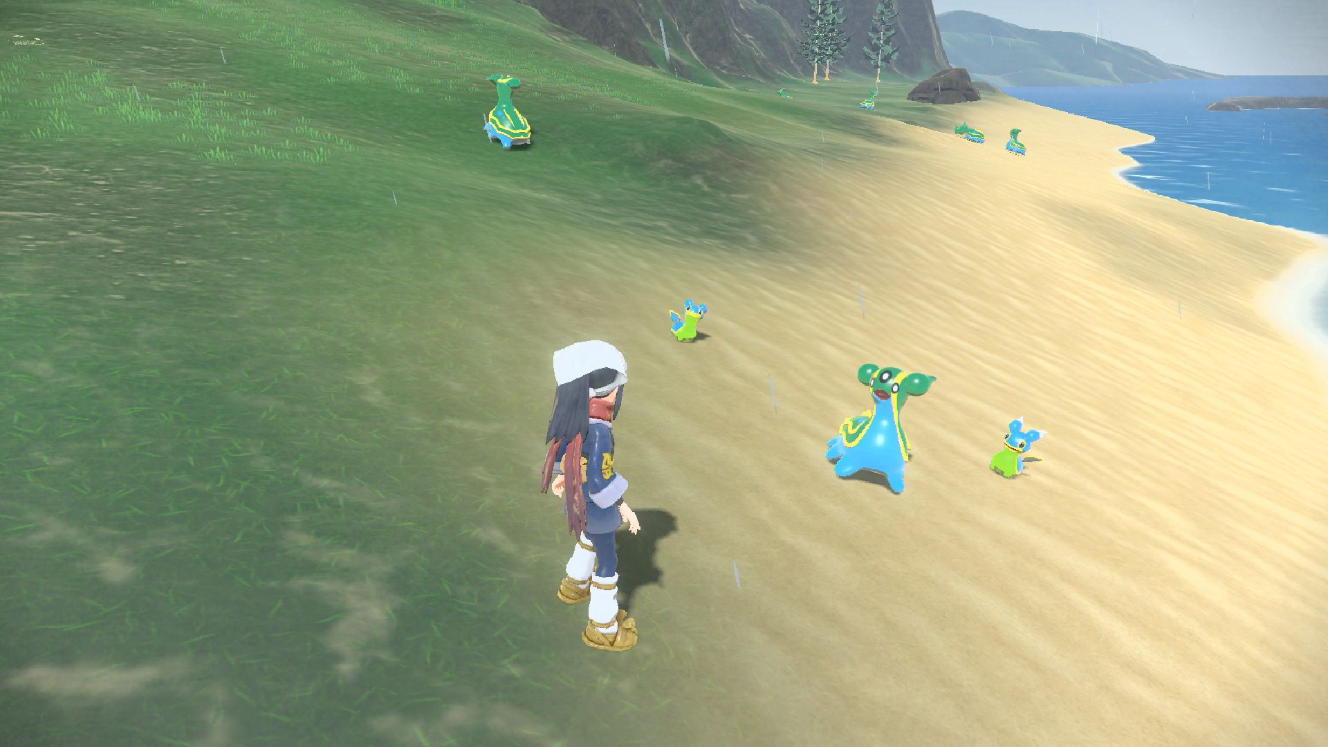 A screenshot of 'Pokémon Legends: Arceus.' The female avatar is on a beach near Shellos and Gastrodon