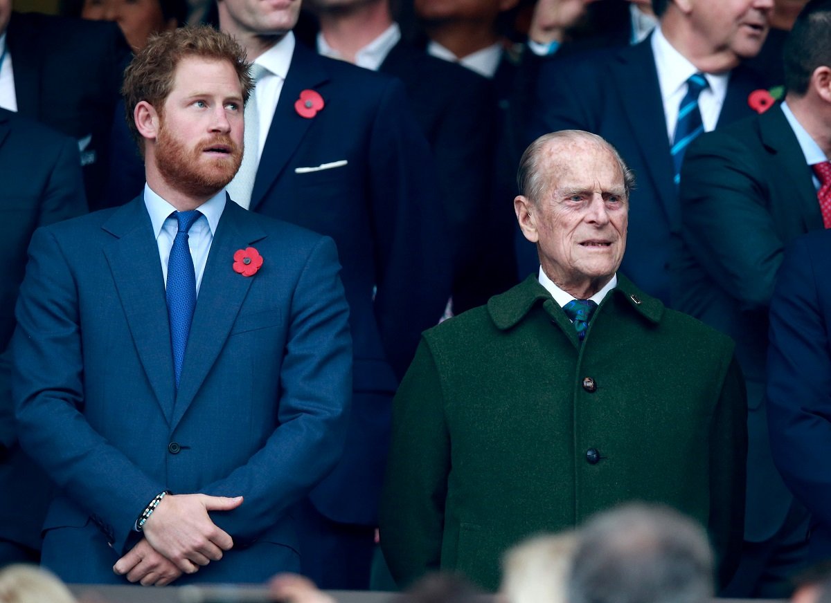 Prince Harry and Prince Philip stand and sing the national anthems at a Rugby World Cup Final
