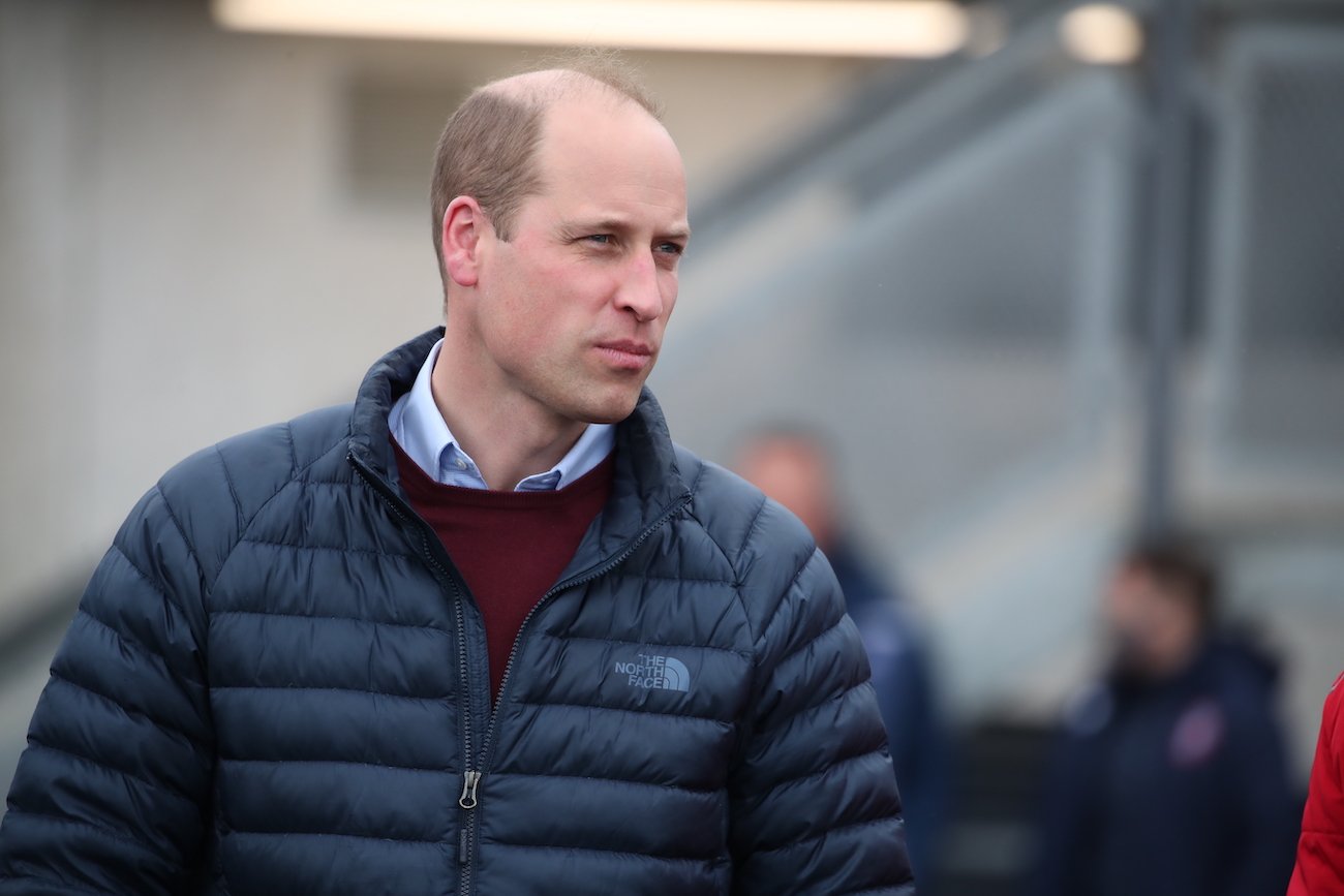 Prince William wearing a black jacket and looking to the right