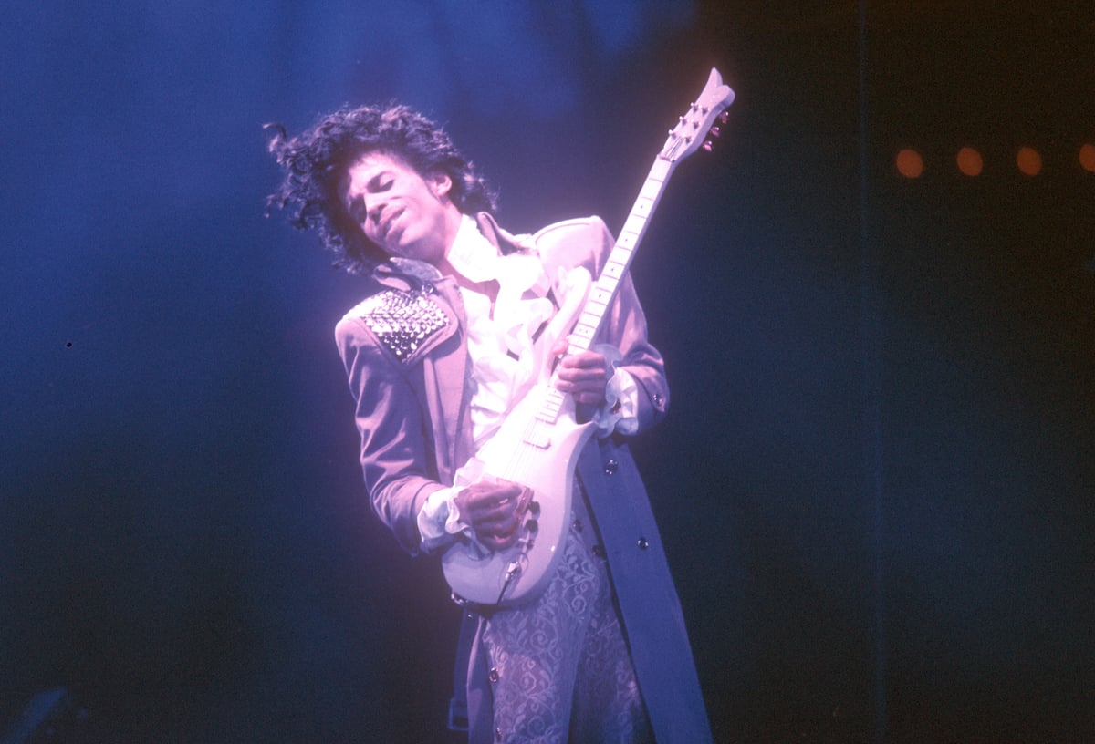 Prince playing guitar on stage