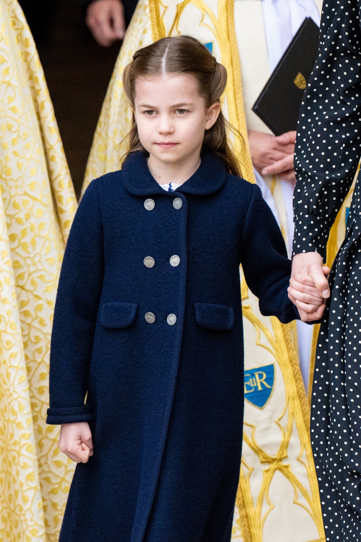 Princess Charlotte holds her mother Kate Middleton's hand at Prince Philip's memorial service