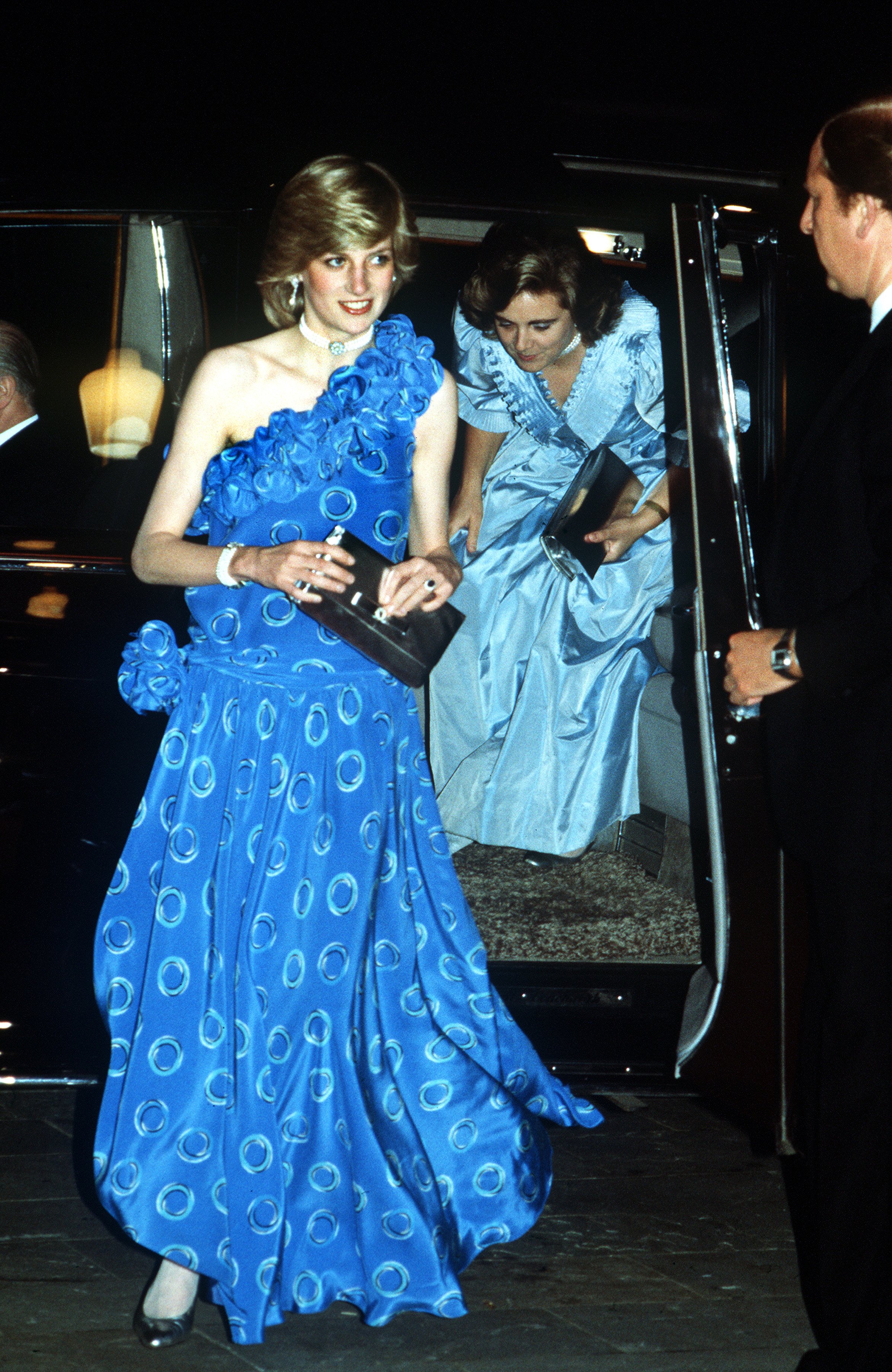 The Princess of Wales arrives at the Guildhall in London for a fashion show, November 1982. She is wearing a blue dress by Bruce Oldfield. She is accompanied by her lady-in-waiting Anne Beckwith-Smith. (Photo by Jayne Fincher/Princess Diana Archive/Getty Images)