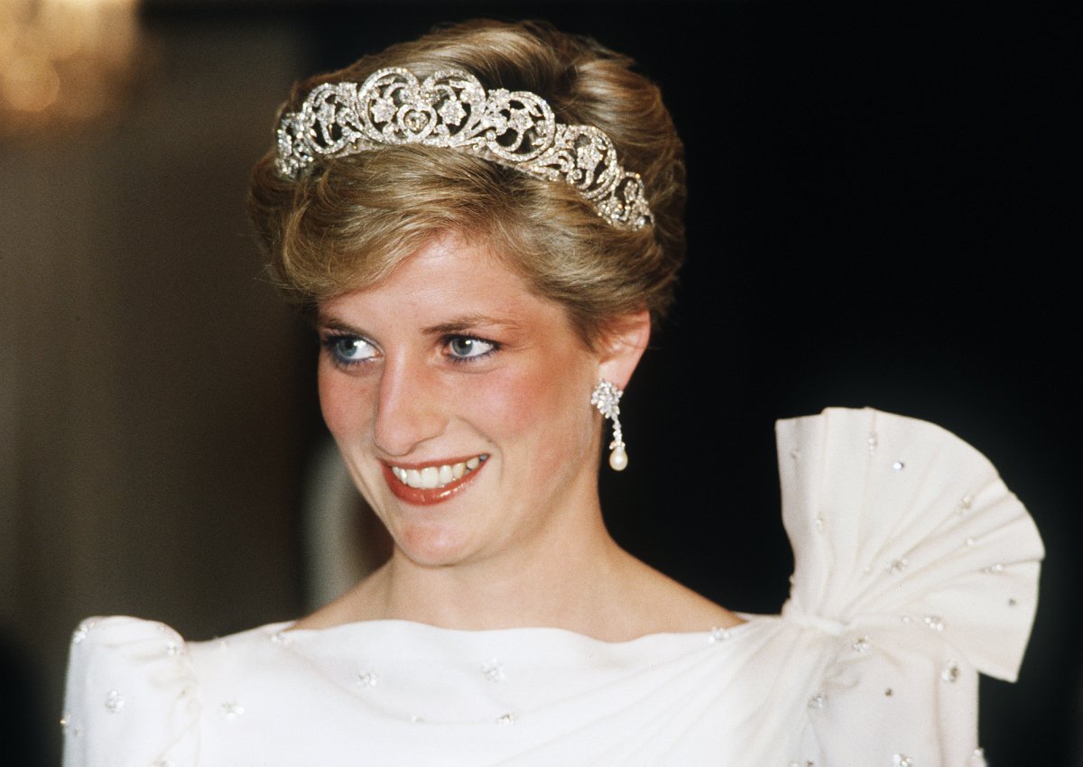 Princess Diana wearing a white dress designed by David and Elizabeth Emanuel with the Spencer Tiara, attends a State Banquet on November 16, 1986 in Bahrain