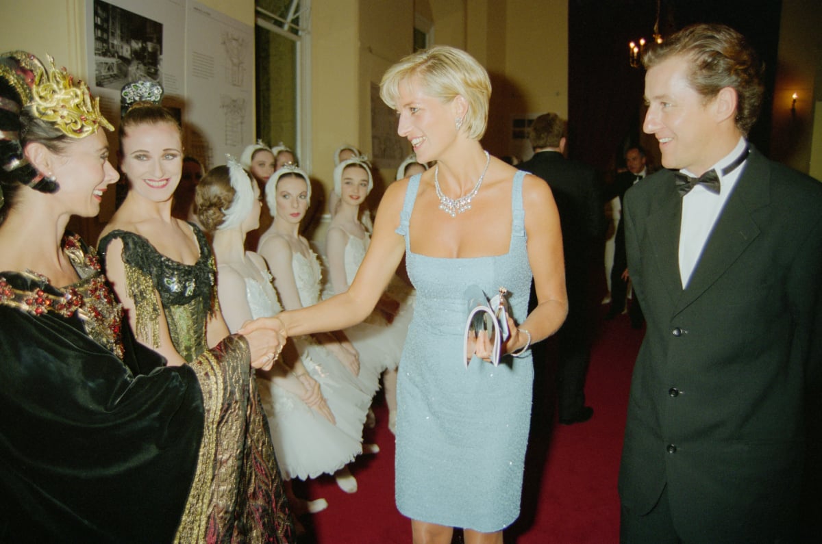 Princess Diana (1961 - 1997) meets members of the cast of an English National Ballet production of 'Swan Lake', at the Royal Albert Hall, London, 3rd June 1997. On the right is artistic director Derek Deane. The Princess is wearing a dress by designer Jacques Azagury