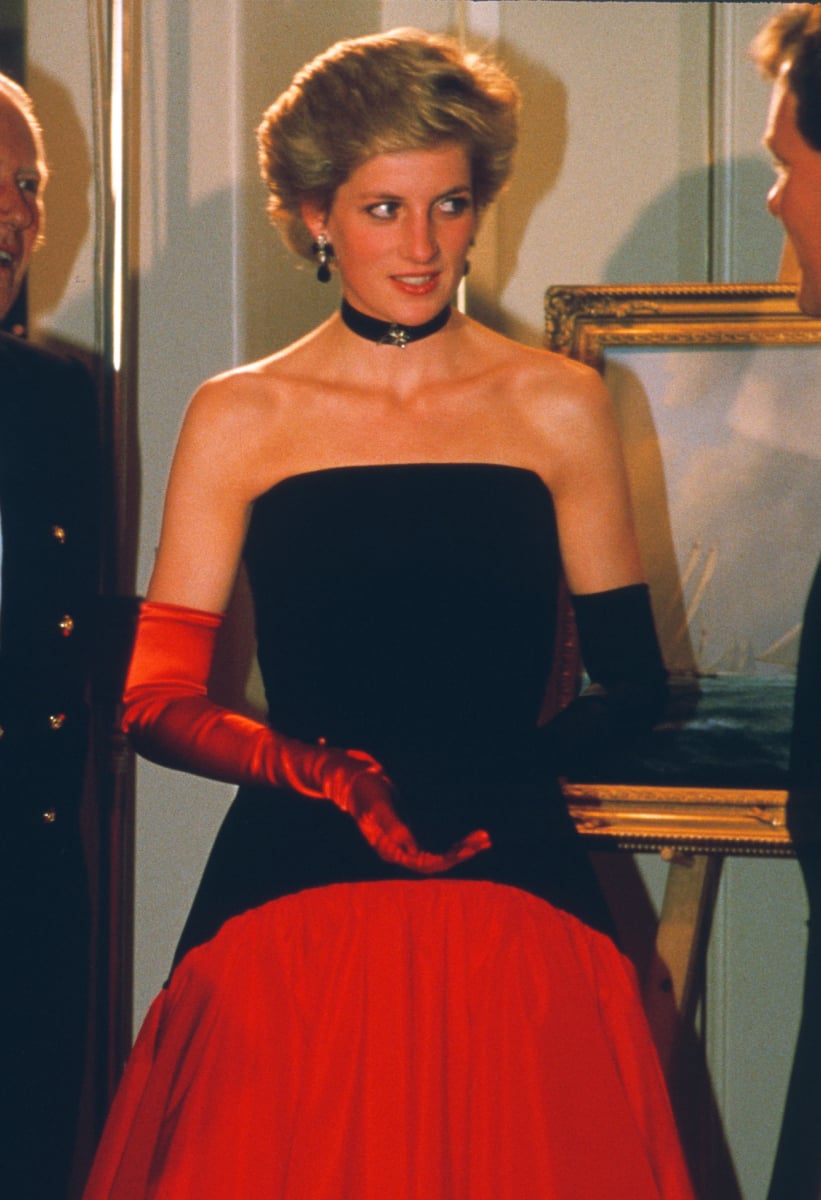 Diana, Princess of Wales, wearing a red taffeta and black velvet Flamenco ball gown designed by Murray Arbeid, a choker and red and black gloves, attends the America's Cup Ball at the Grosvenor House Hotel on September 19, 1986 in London, United Kingdom