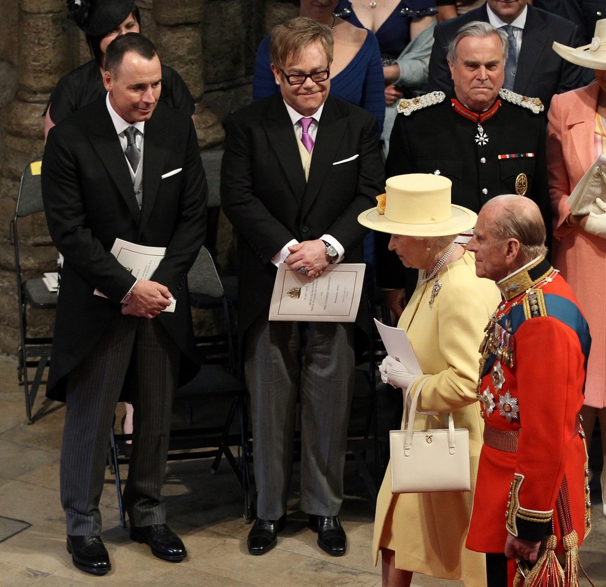 Queen Elizabeth II and Prince Philip walk past Elton John and David Furnish as they arrive for Prince William and Kate Middleton's wedding