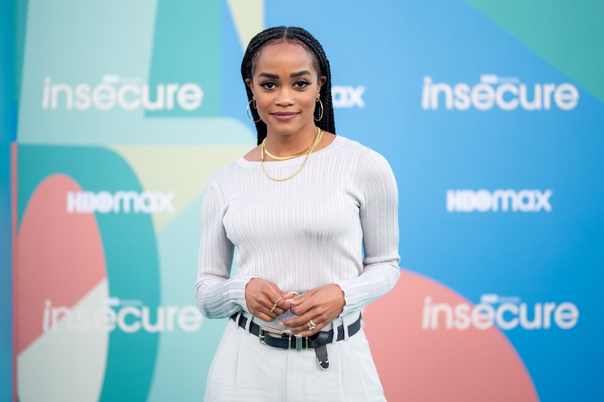 Rachel Lindsay poses on the red carpet in a white dress at HBO's final season premiere of 'Insecure'