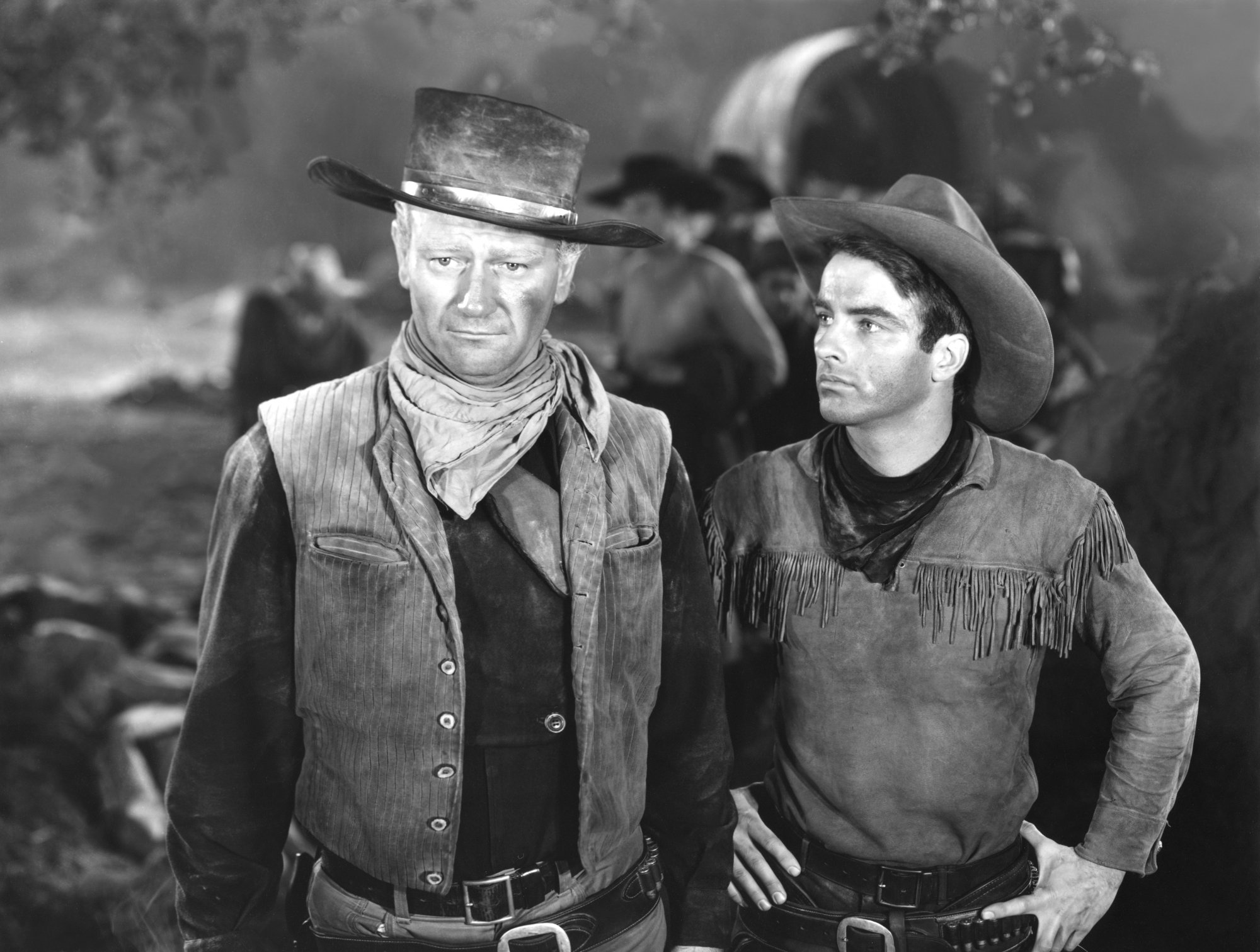 'Red River' actors John Wayne as Thomas Dunson and Montgomery Clift as Matt Garth on the set wearing period Western clothes