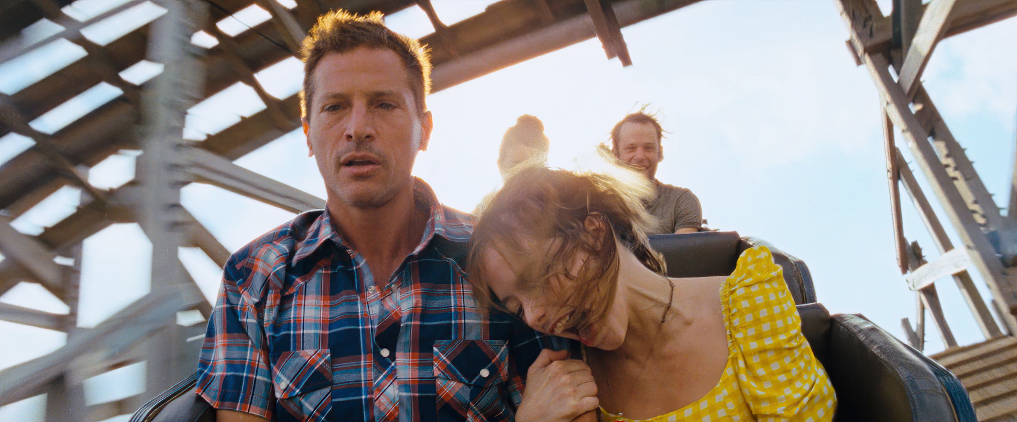 'Red Rocket' Simon Rex as Mikey and Suzanna Son as Strawberry on a rollercoaster with her holding onto his arm