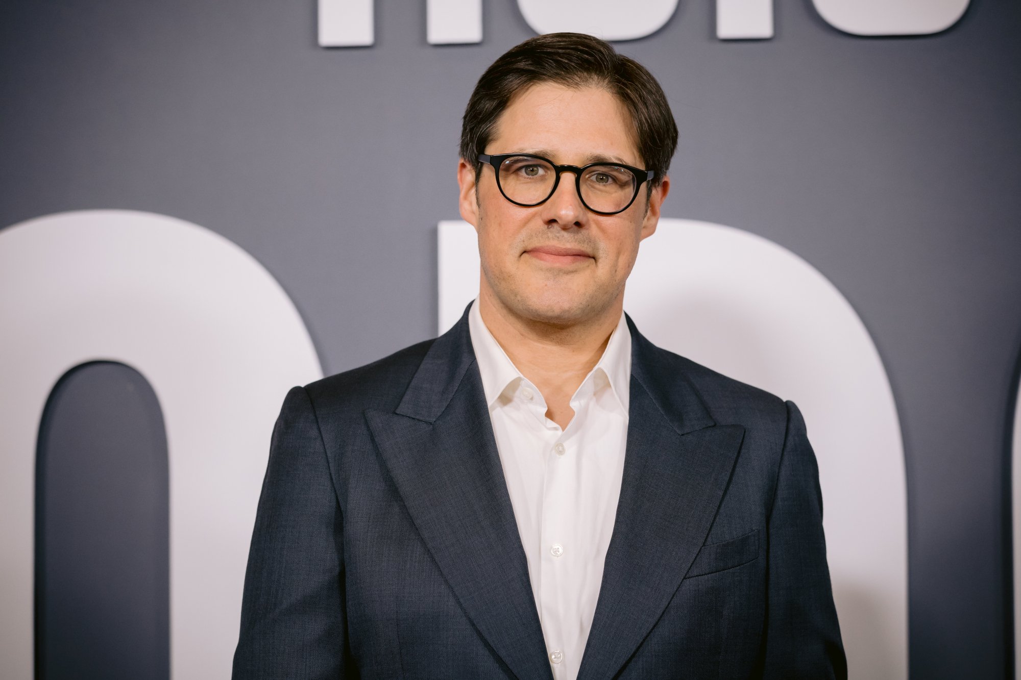 Rich Sommer at the premiere for 'The Dropout.' He's wearing a suit and looking at the camera.