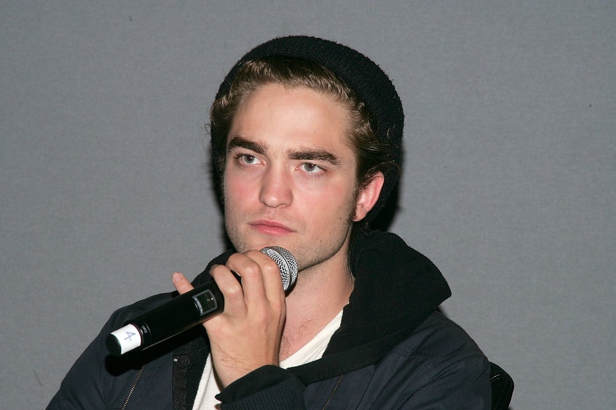 Robert Pattinson holding a microphone.