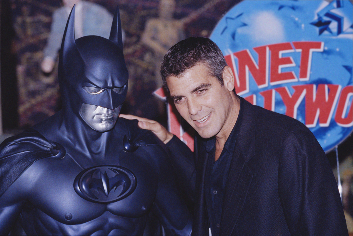 'Batman & Robin' actor George Clooney with his Batman suit which Robert Pattinson wore for his screentest