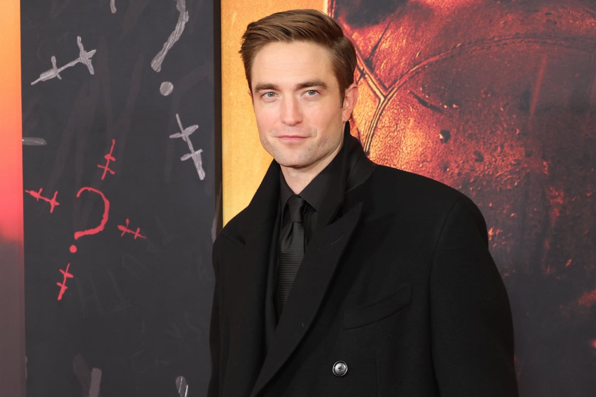 Robert Pattinson wearing a black suit and jacket attends "The Batman" World Premiere on March 01, 2022 in New York City