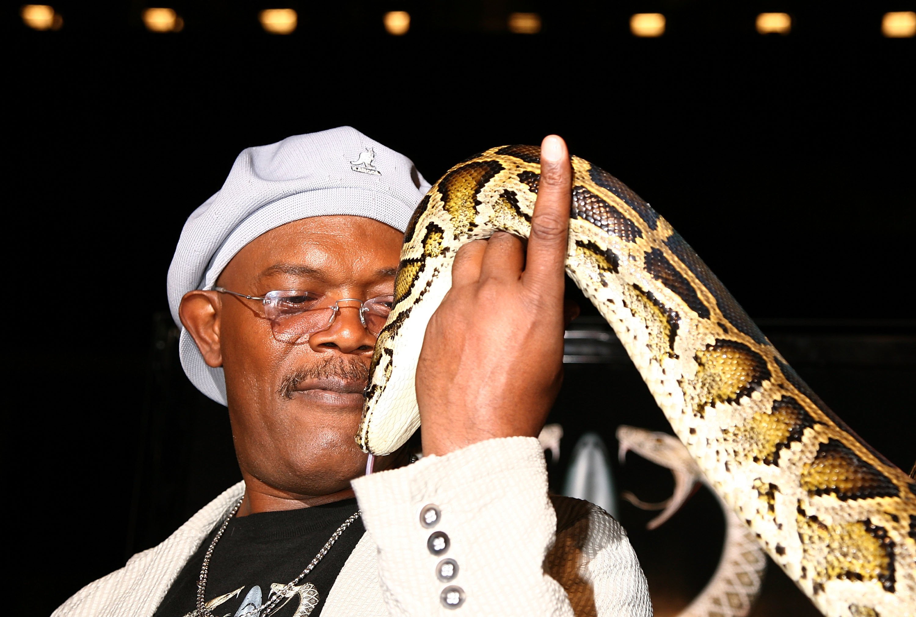 Samuel L. Jackson holds a snake at the movie premiere of Snakes on a Plane