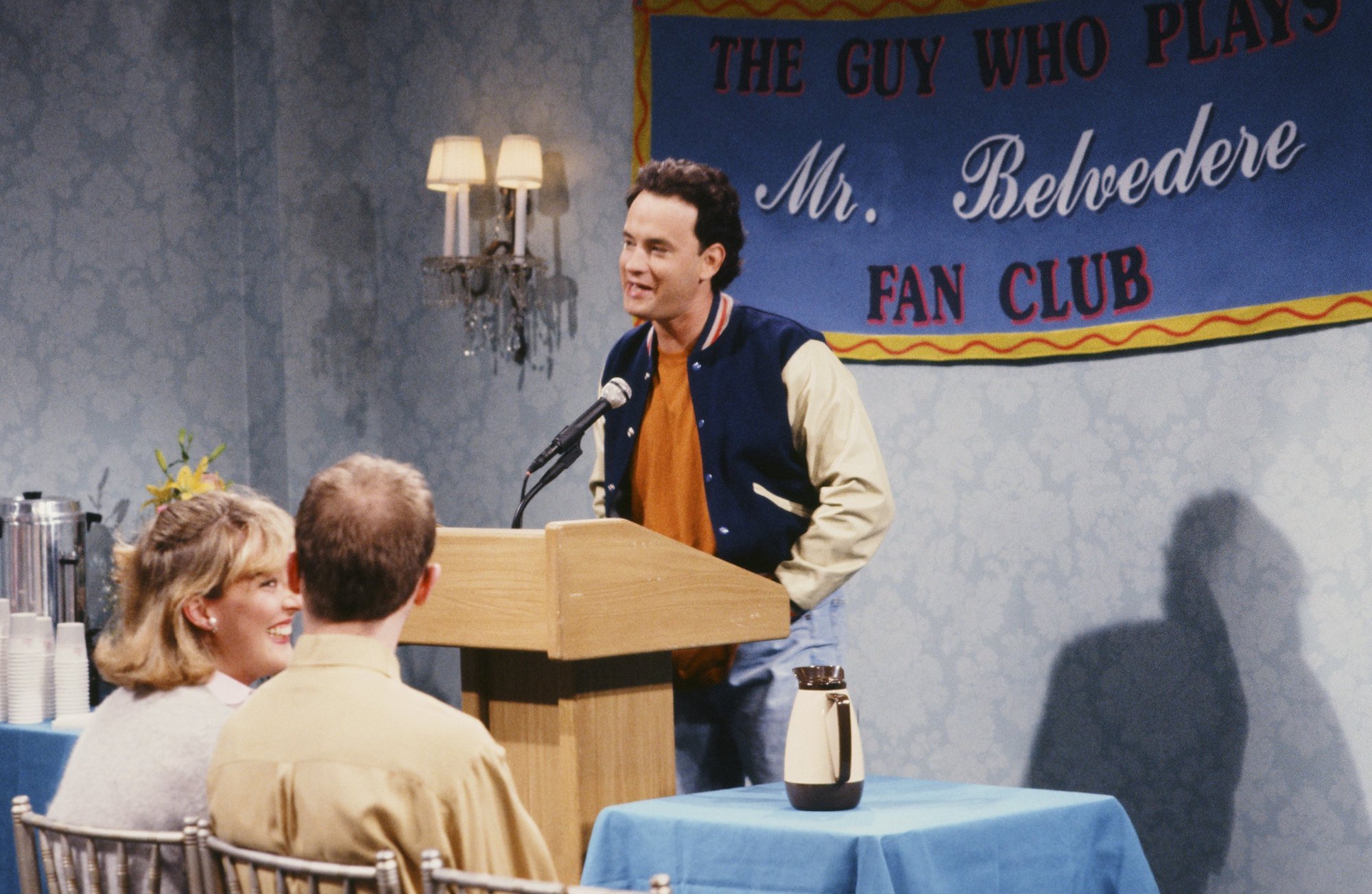 'Saturday Night Live' host Tom Hanks speaks at a podium for the Mr. Belvedere Fan Club sketch 