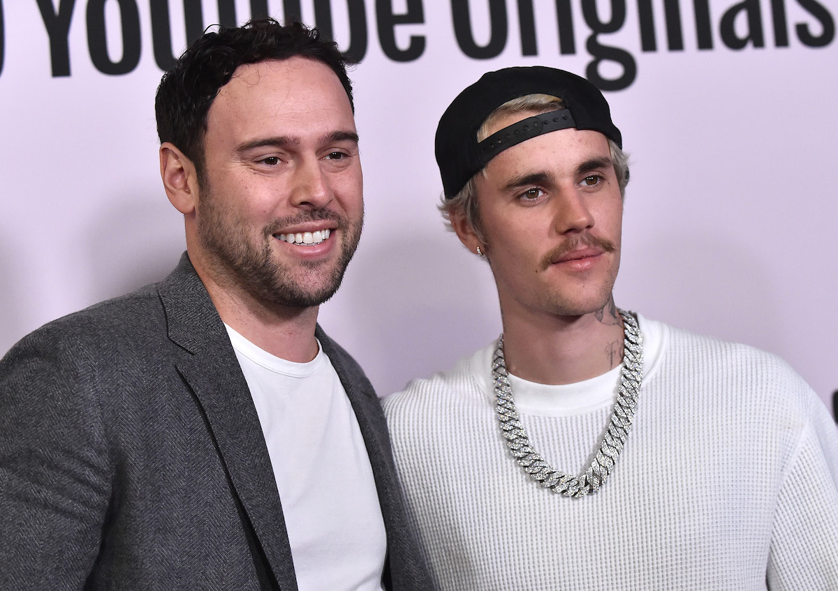 Scooter Braun and Justin Bieber pose together at an event.