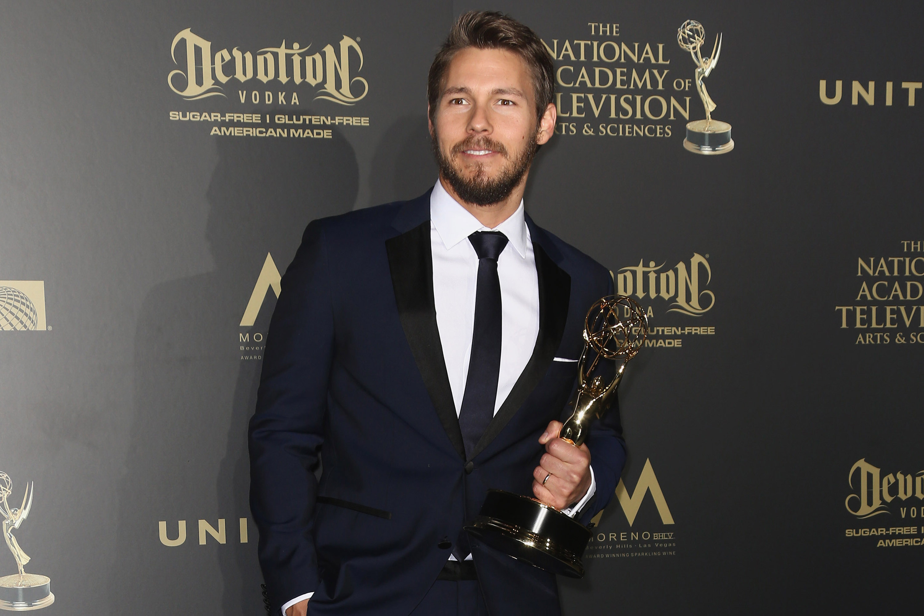 'The Bold and the Beautiful' actor Scott Clifton wearing a tuxedo and holding a Daytime Emmy.