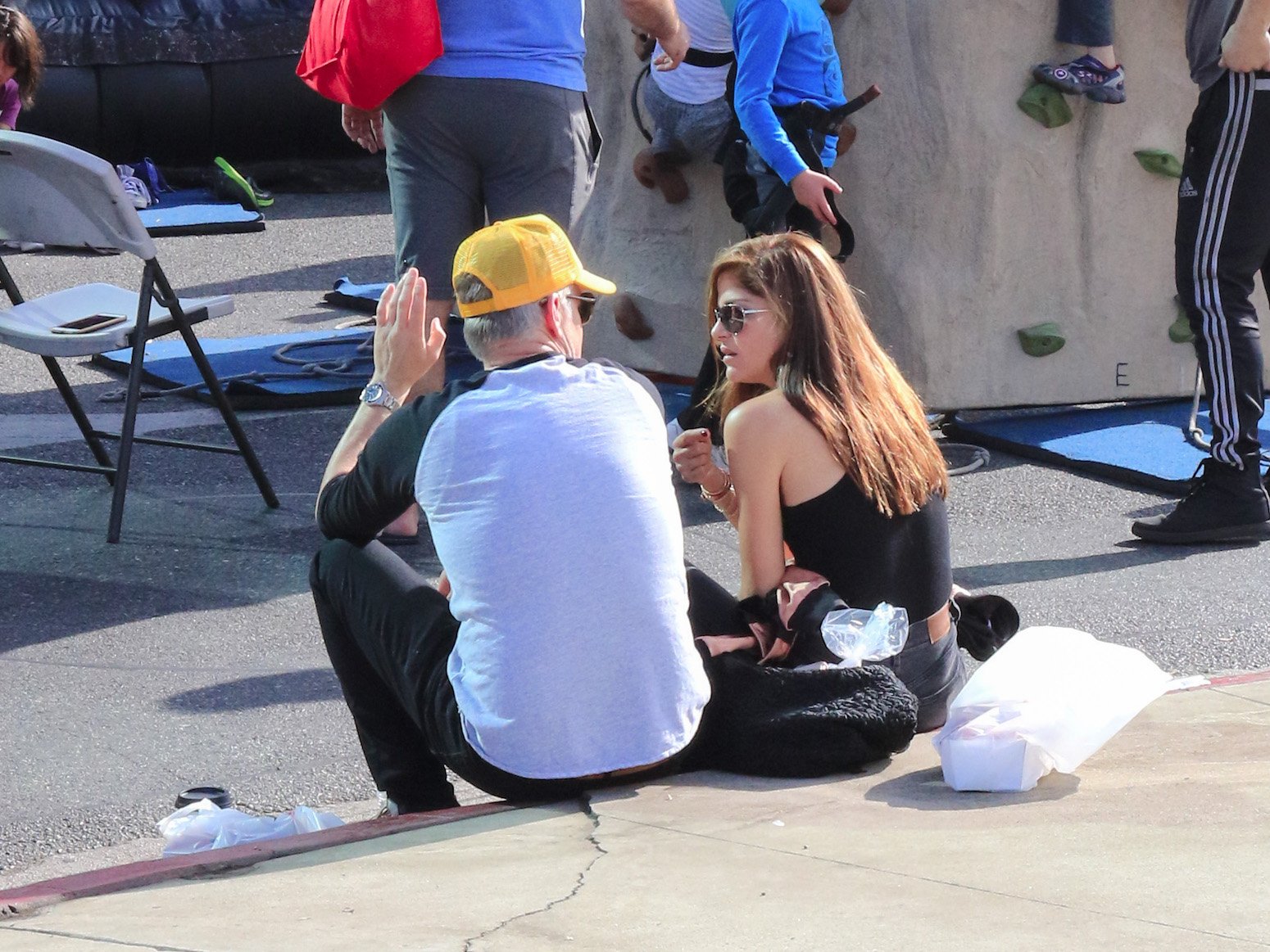 Selma Blair and Ron Carlson sitting on a step together outside