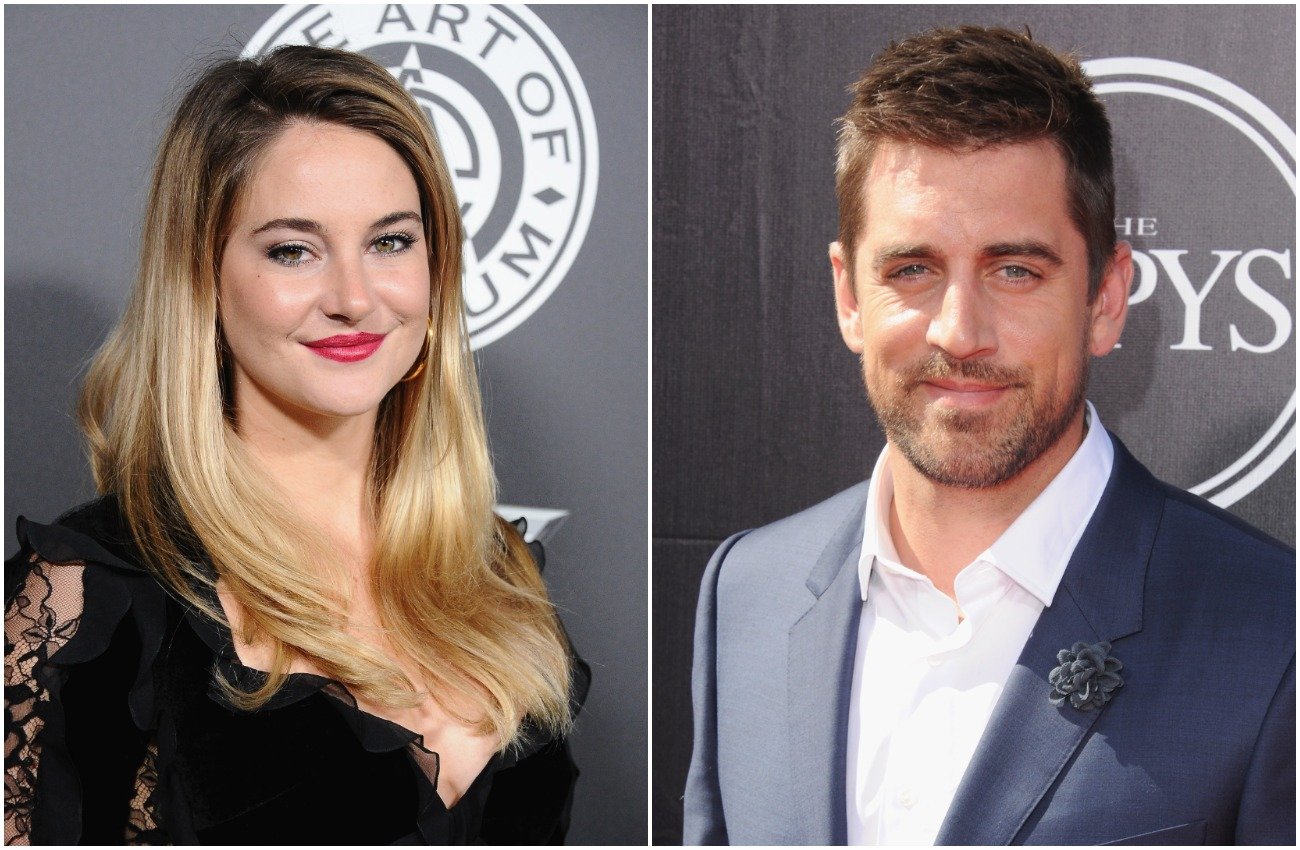Shailene Woodley with long blonde and hair and black outfit, Aaron Rodgers wearing a gray suit