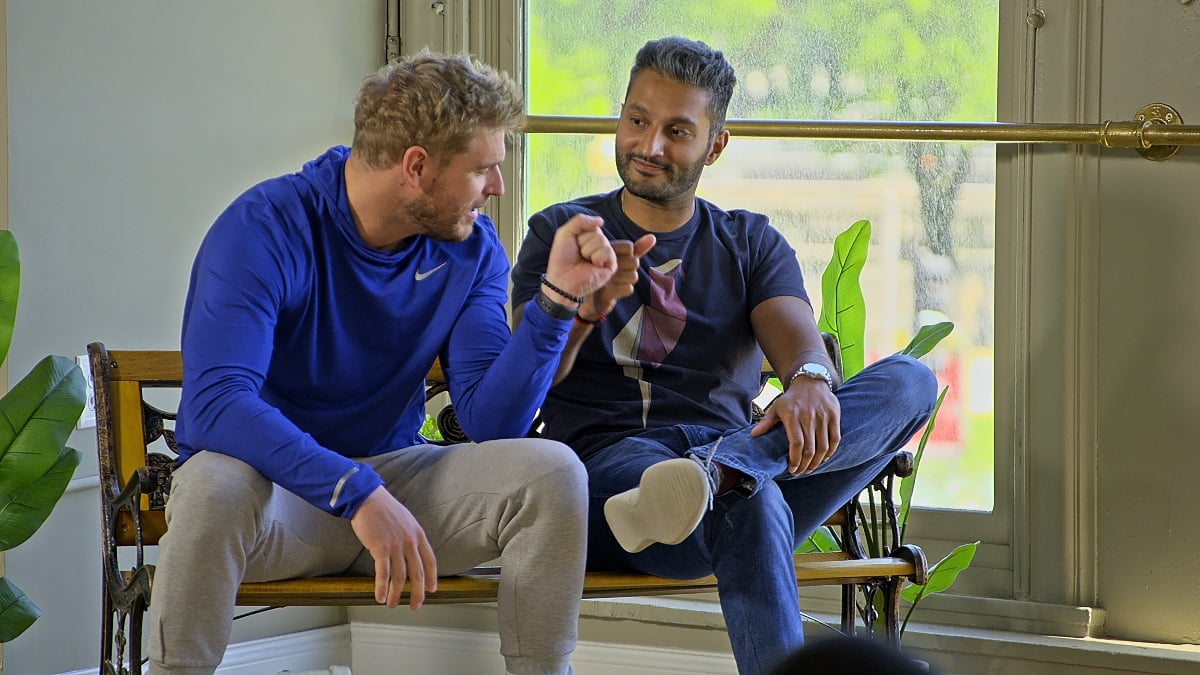 Shayne Jansen and ‘Shake’ Chatterjee fist-bumping on the set of 'Love Is Blind'.