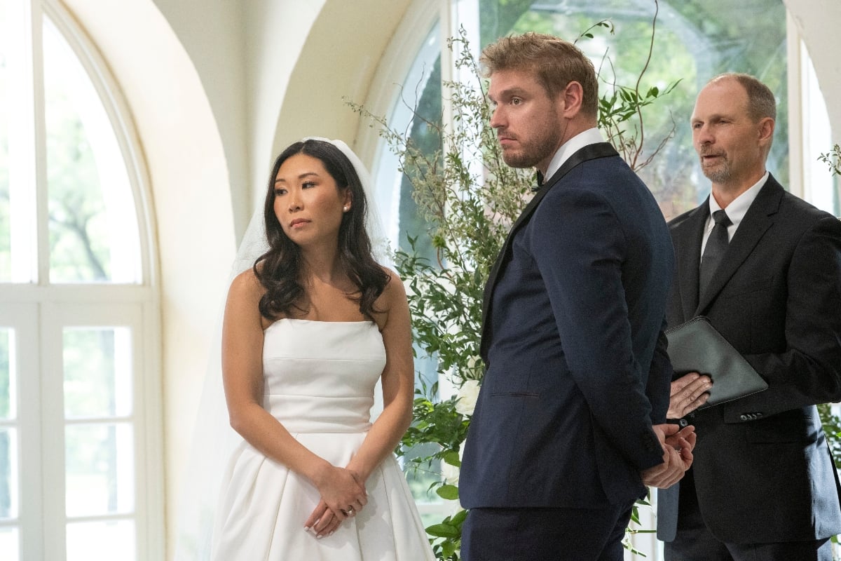 Shayne Jansen wearing a tux and Natalie Lee wearing a wedding dress standing at the wedding altar on 'Love Is Blind'