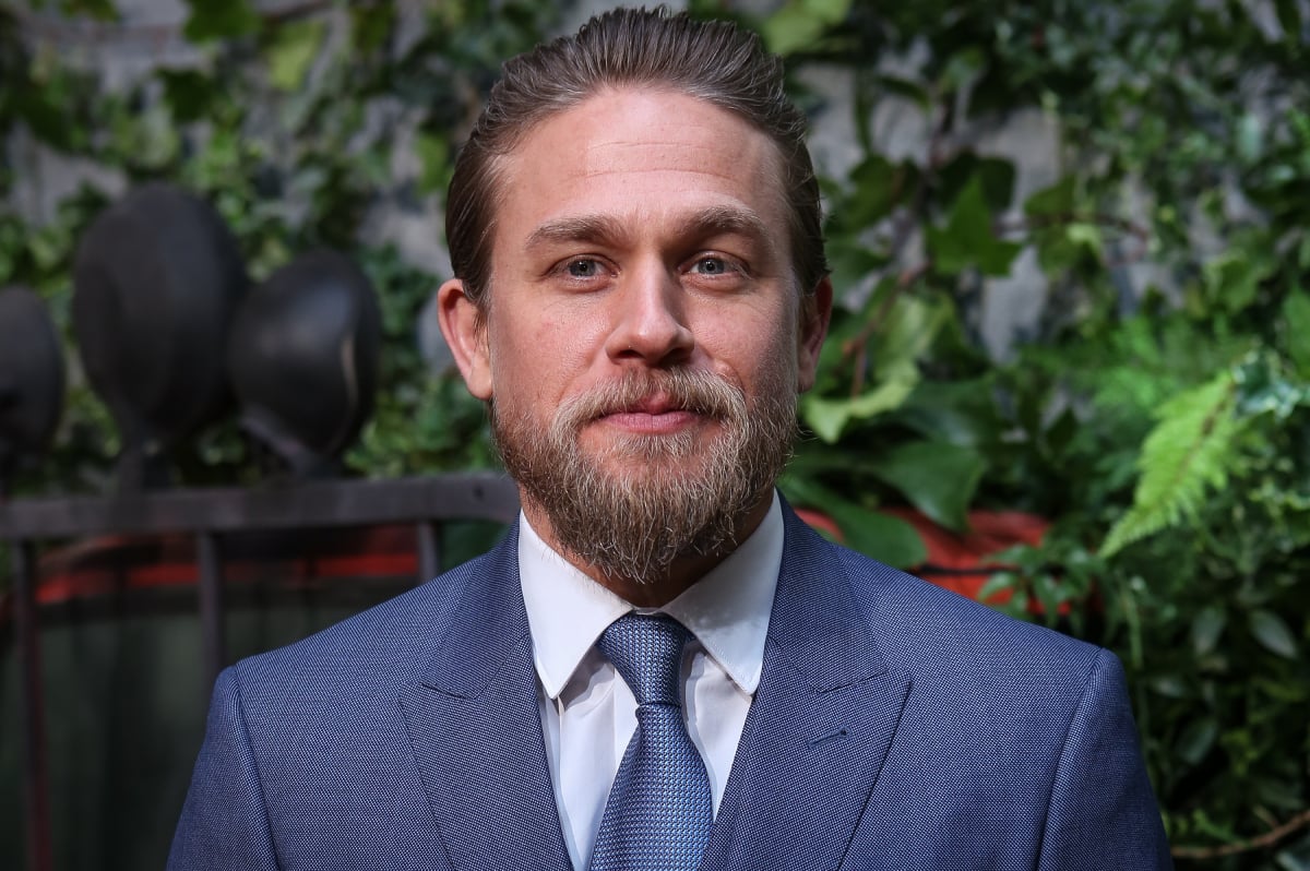 Sons of Anarchy star Charlie Hunnam in a blue suit and a goatee at the Triple Frontier premiere