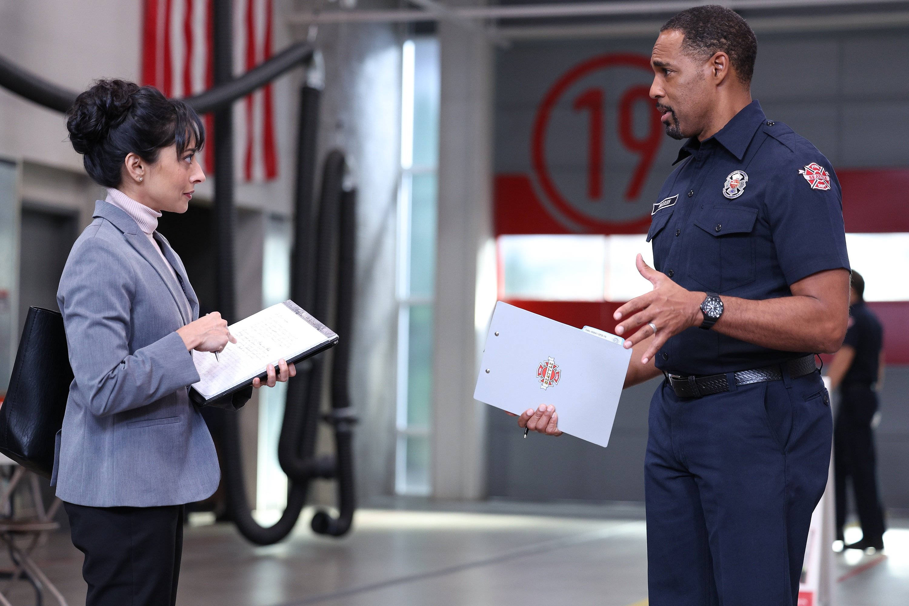 'Station 19': Nitya Vidyasagar and Jason George talk with paperwork in their hands