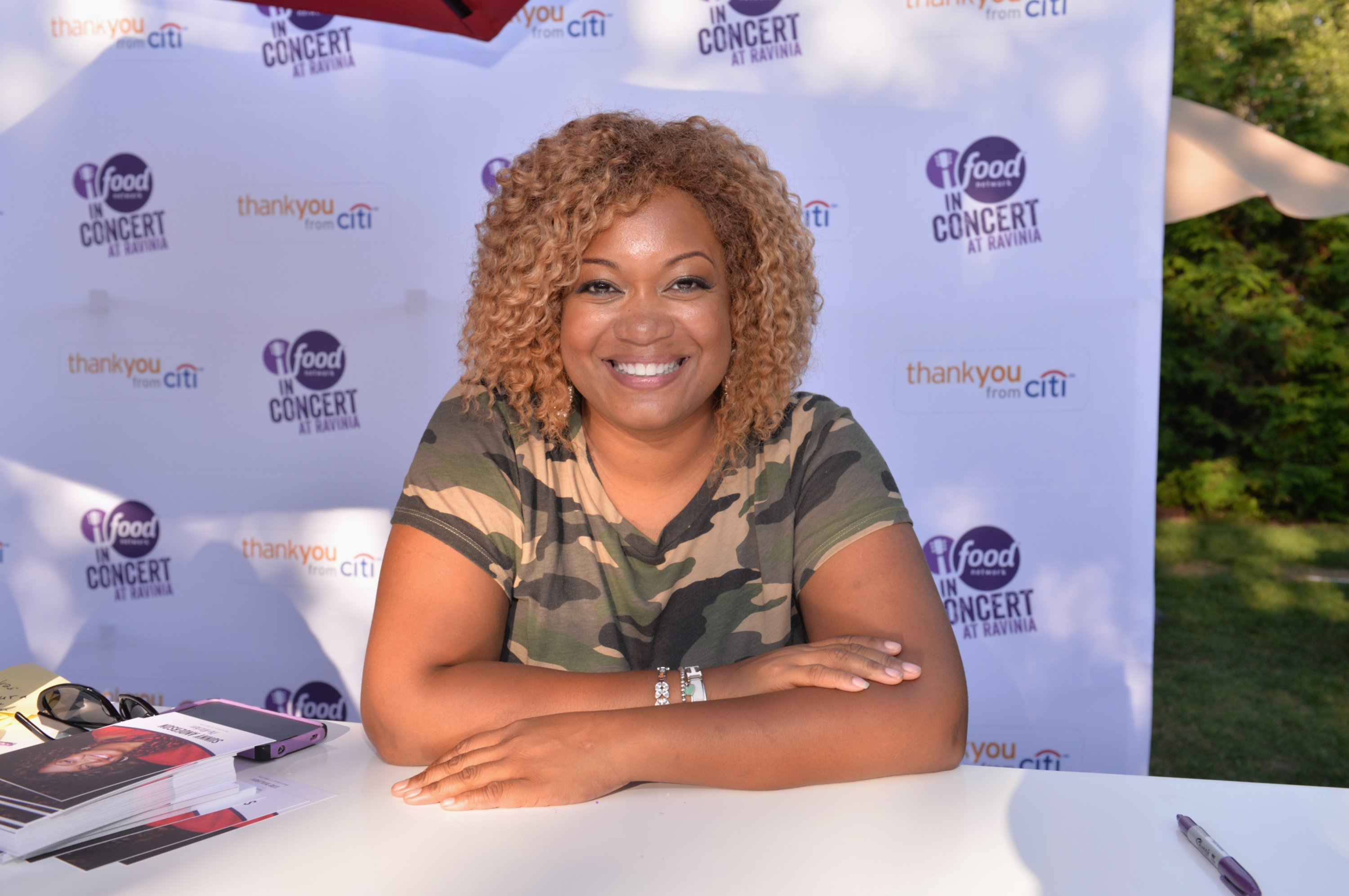 Food Network personality Sunny Anderson wears a camo print tee in this photograph.