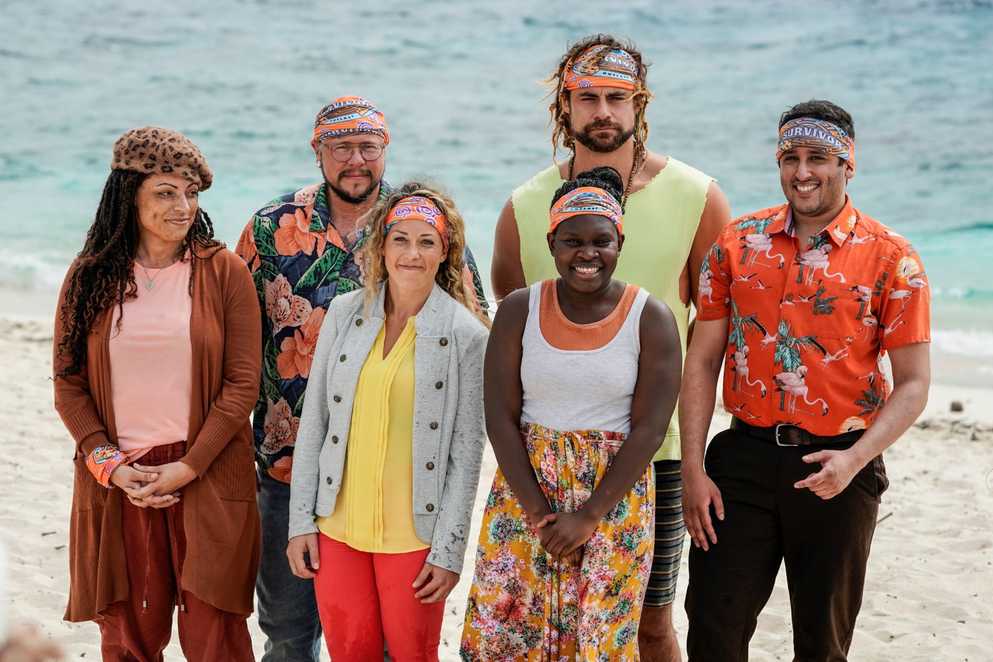'Survivor' Season 42 castaways Marya Sherron, Jackson Fox, Lindsay Dolashewich, Jonathan Young, Maryanne Oketch, and Omar Zaheer stand together on a beach, all wearing their orange buffs. Marya, Jackson, Lindsay, Jonathan, Maryanne, and Omar make up the Taku tribe, and 'Survivor' Season 42 spoilers indicate one of them will have to be medically evacuated.