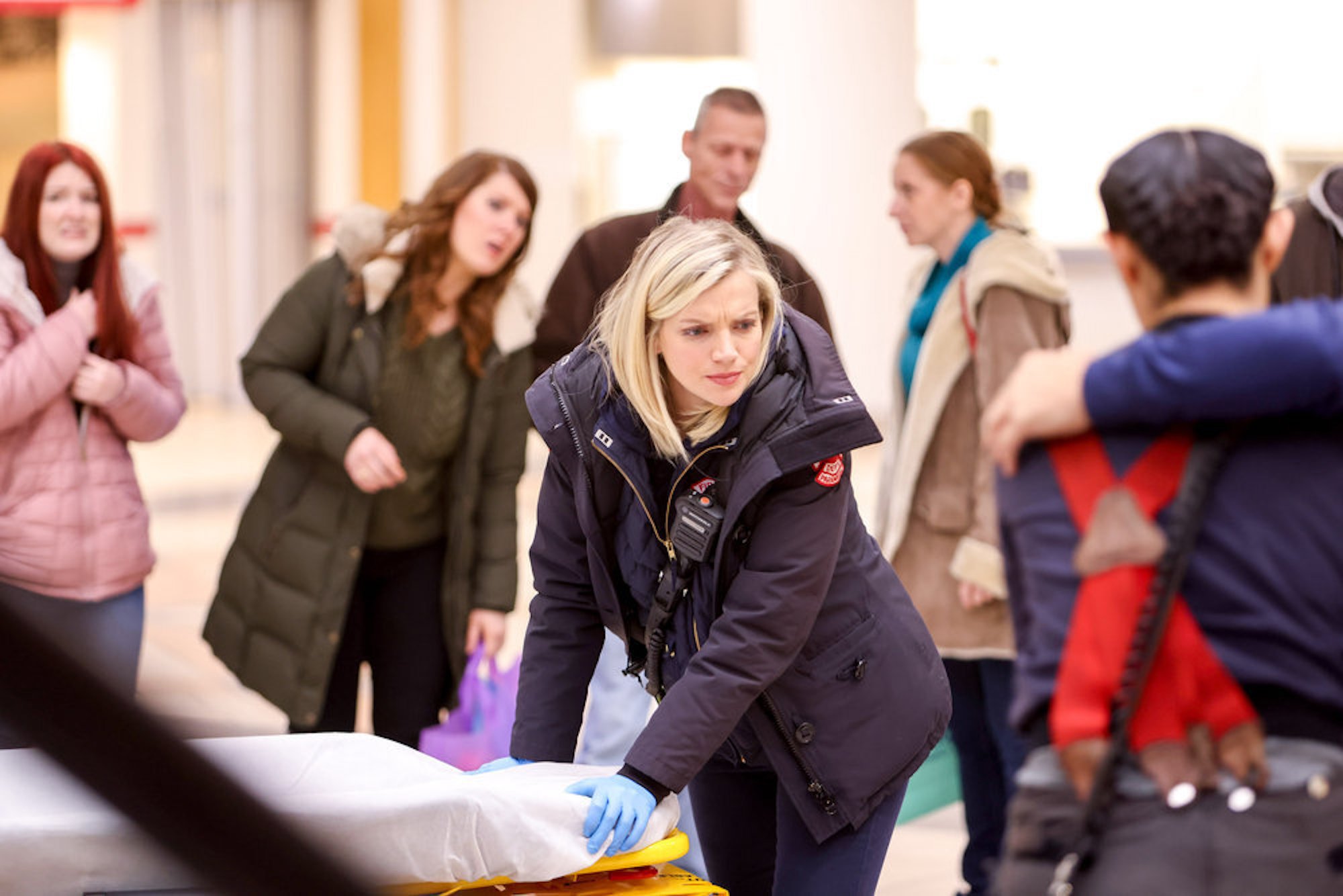 Sylvie Brett in 'Chicago Fire' Season 10 with her hands on a pillow looking concerned with others around her