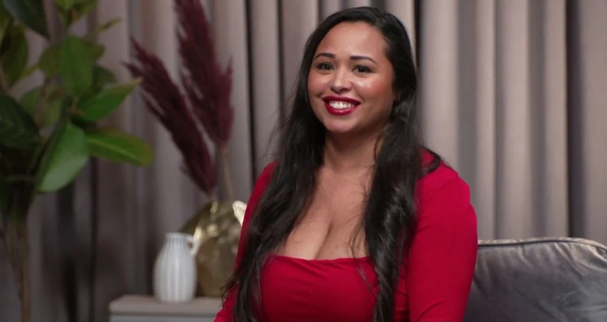 Tania Maduro wearing a red dress on the set of '90 Day: The Single Life' Season 2 tell-all.