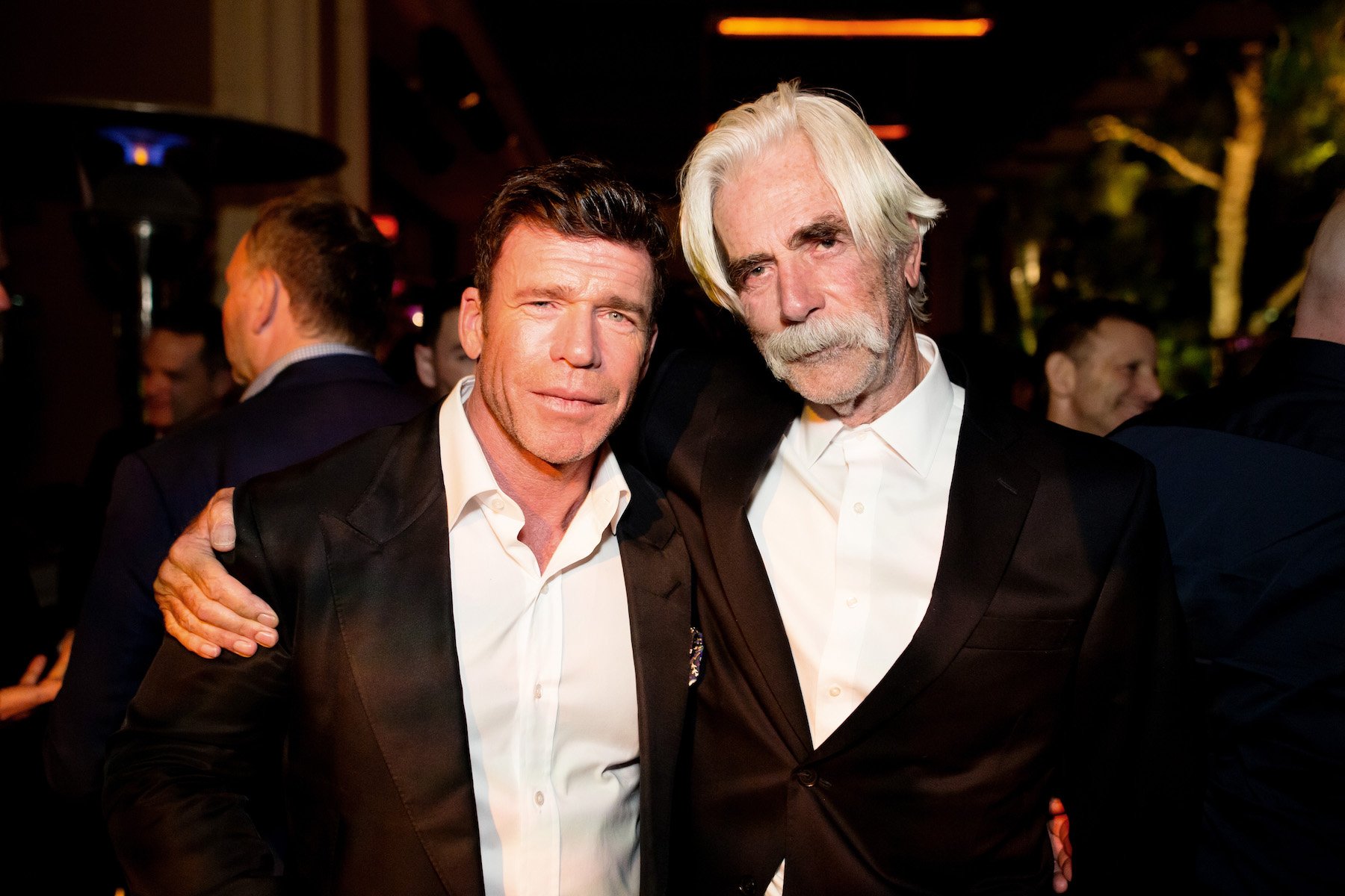 '1883' creator standing next to Sam Elliott at a premiere