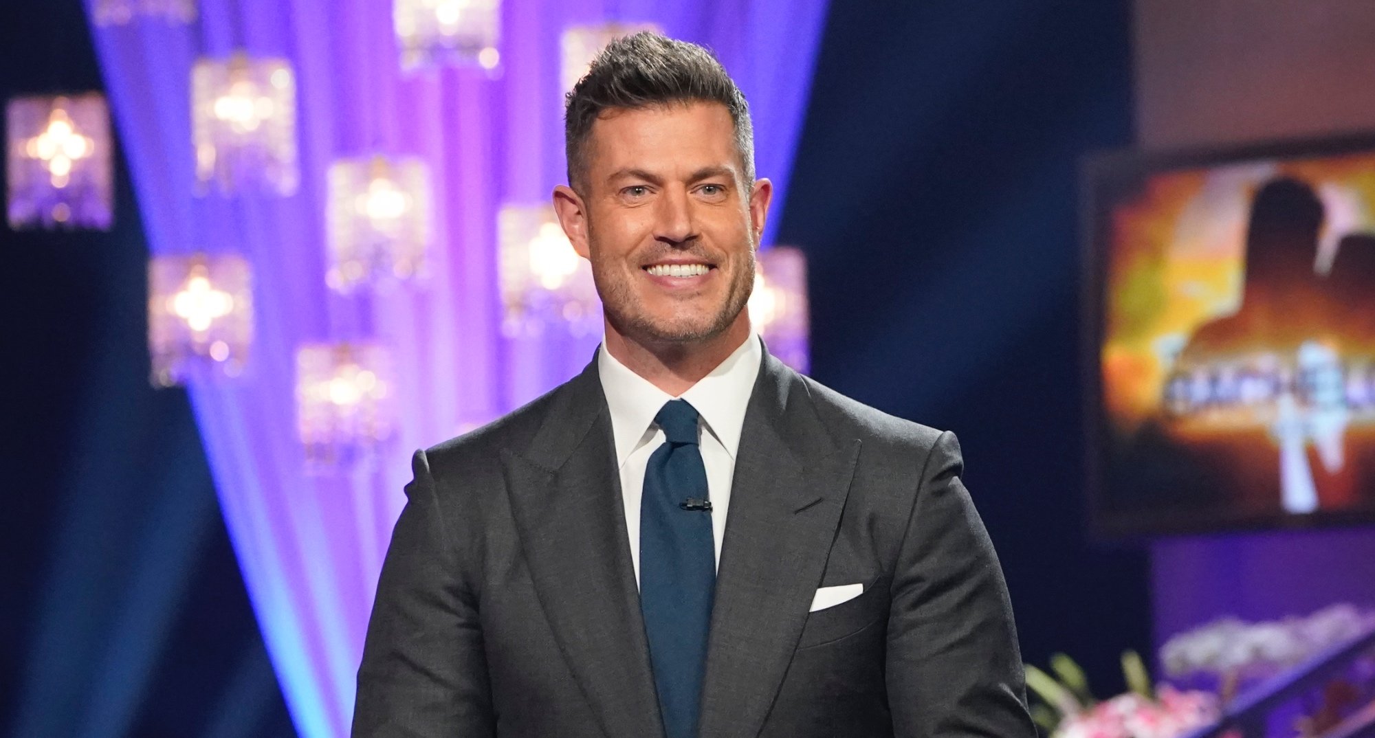'The Bachelor' host Jesse Palmer wearing grey suit and blue tie.