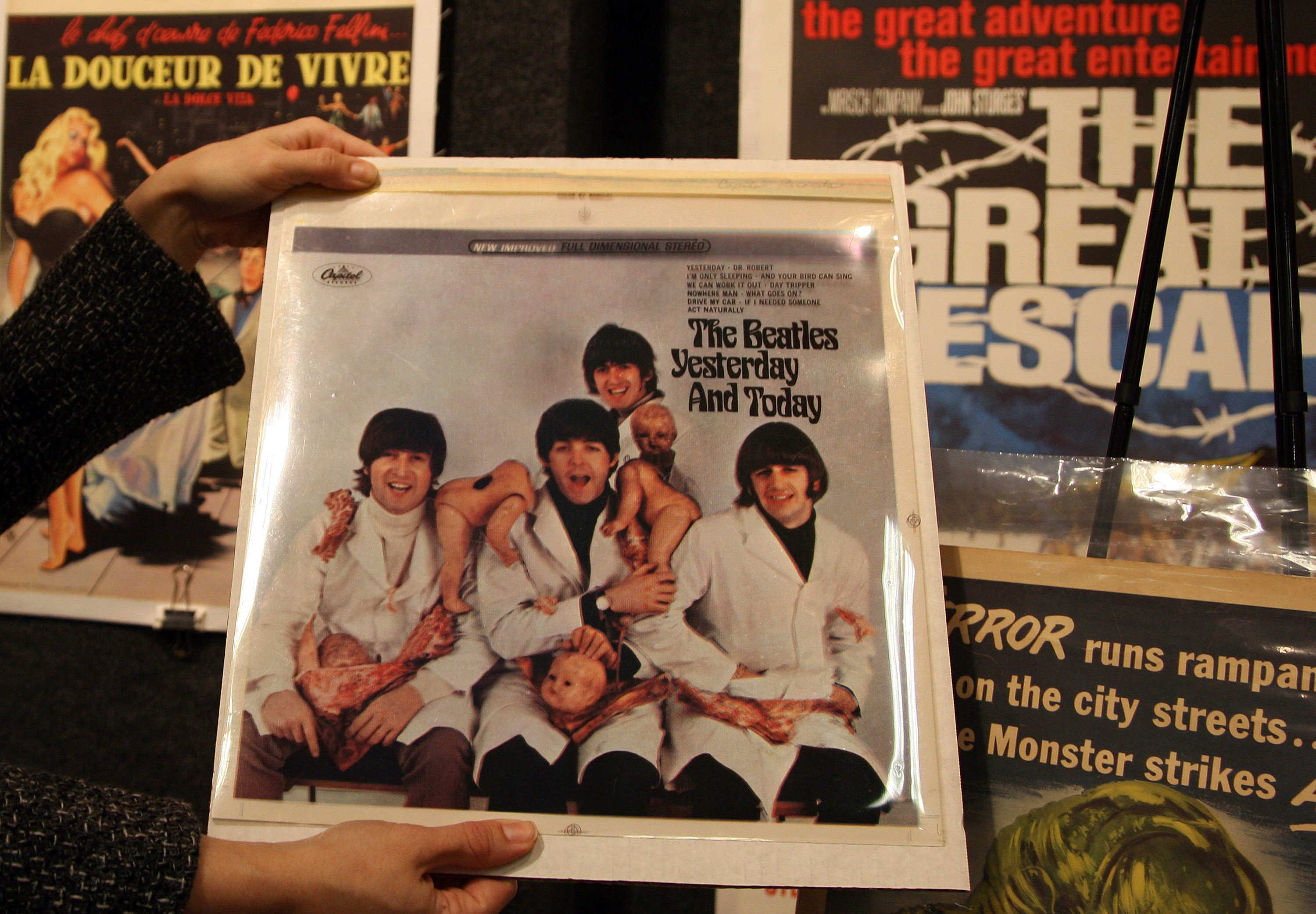Someone holding a copy of The Beatles' 'Yesterday and Today,' the album that contains "Day Tripper"