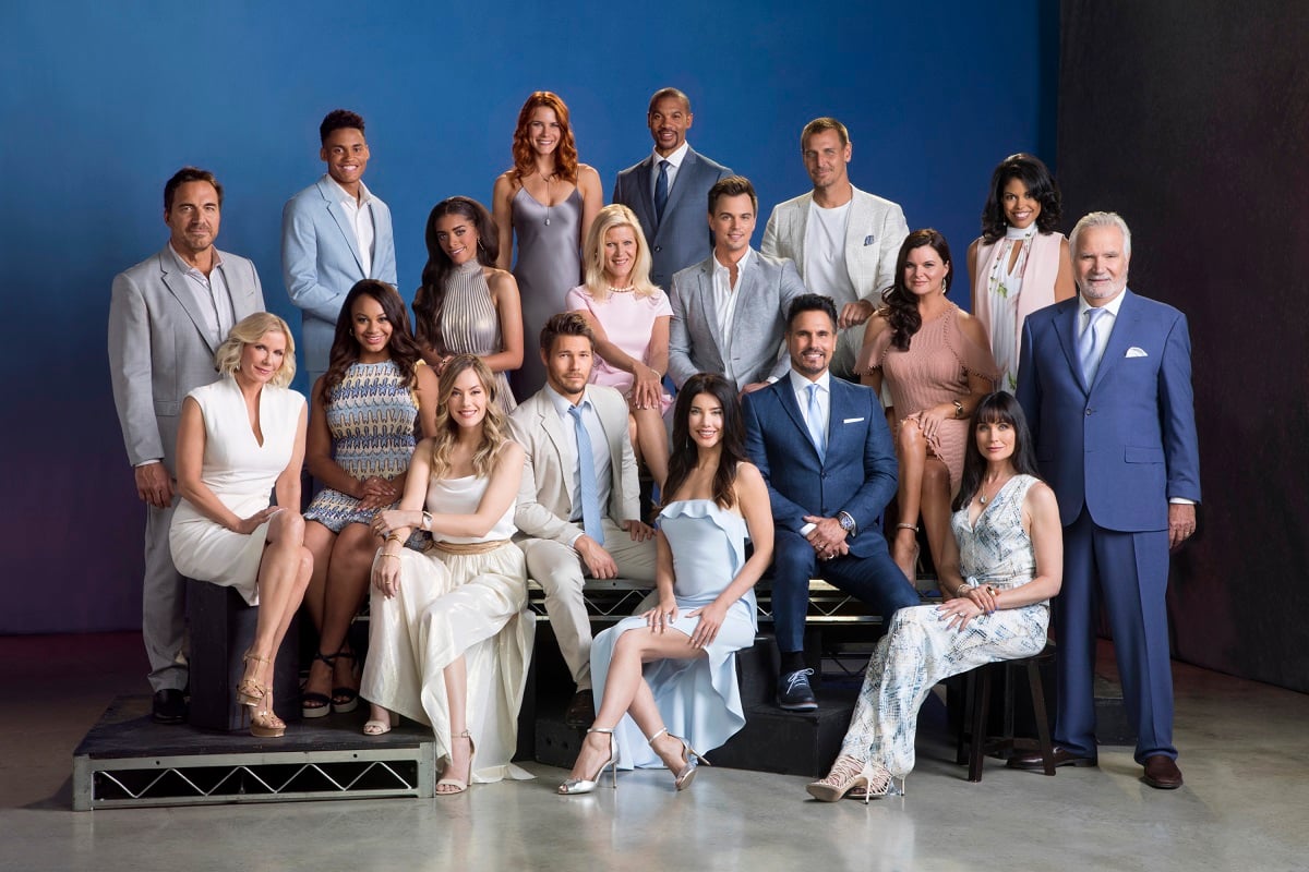 'The Bold and the Beautiful' cast pose for a group photo in front of a blue backdrop.