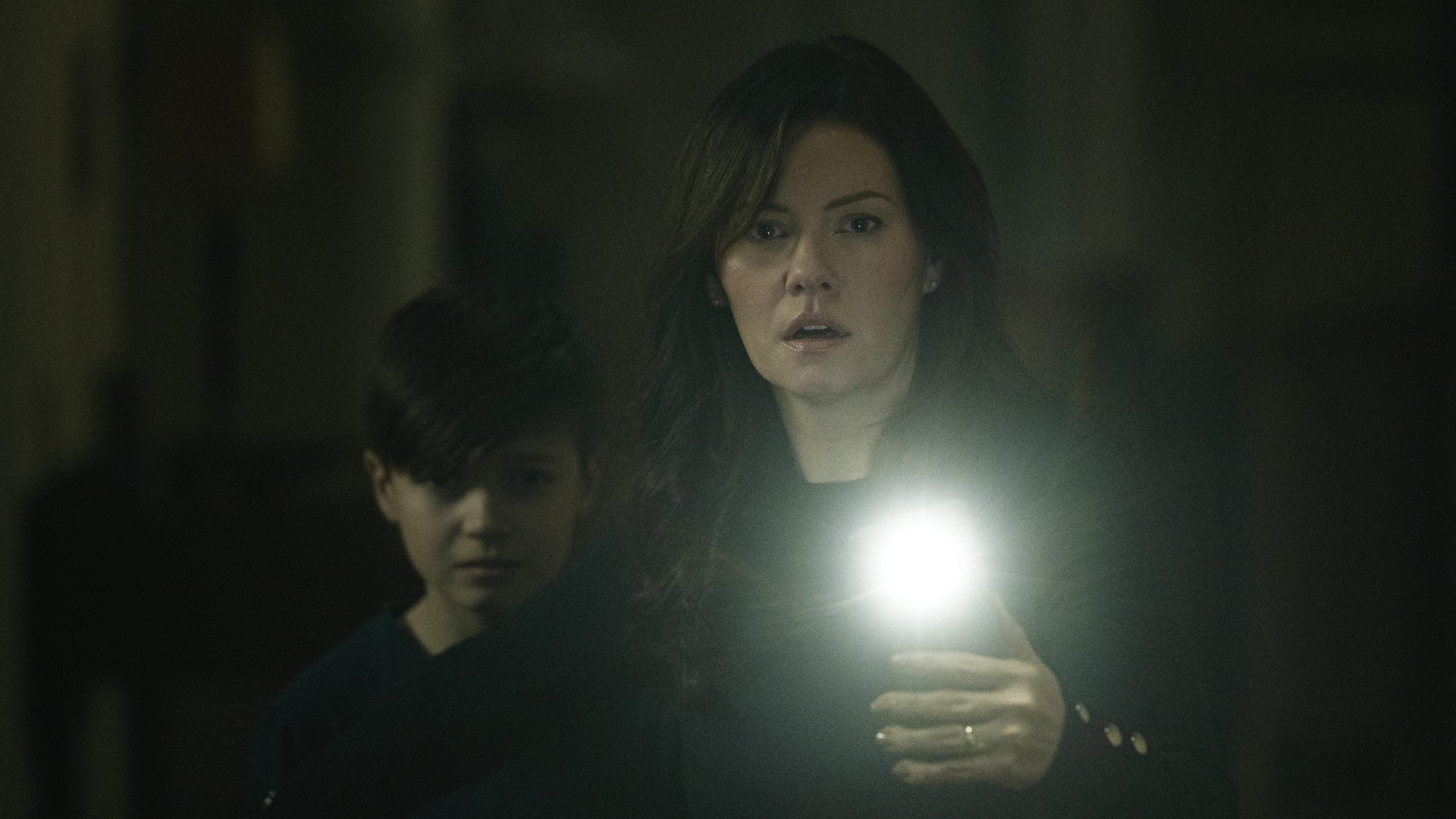 'The Cellar' Dylan Fitzmaurice Brady as Steven and Elisha Cuthbert as Keira looking scared with a phone flashlight on