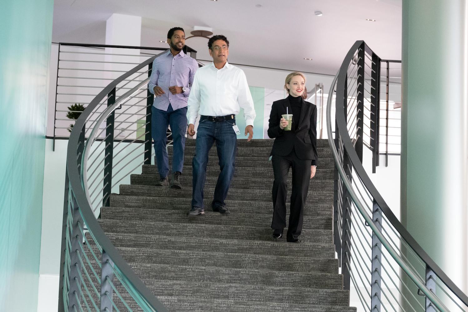 Daniel Young, Sunny Balwani, and Elizabeth Holmes walking together in 'The Dropout'