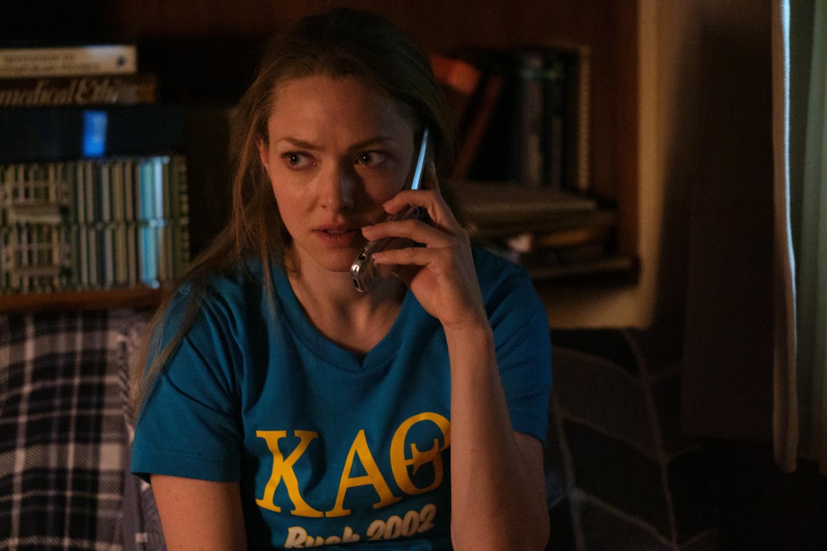 Amanda Seyfried as Elizabeth Holmes in The Dropout, a Hulu series based on a true story. Holmes talks on the phone wearing a Stanford shirt.