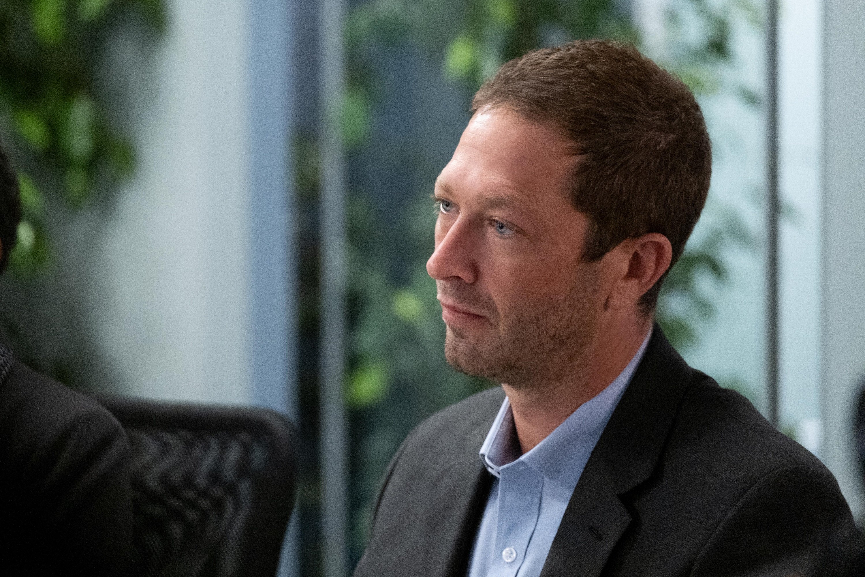 'The Dropout' Ebon Moss-Bachrach plays journalist John Carreyrou of the Wall Street Journal looking at someone