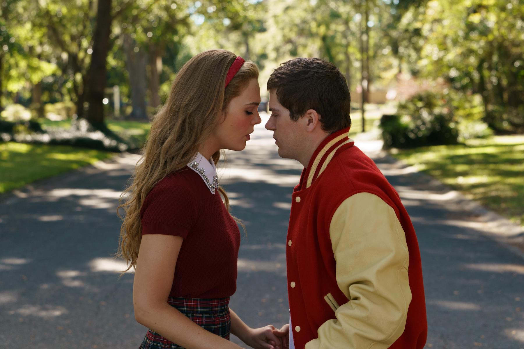 Elle Fanning as Michelle Carter and and Colton Ryan as Conrad Roy holding hands face to face in 'The Girl From Plainville'
