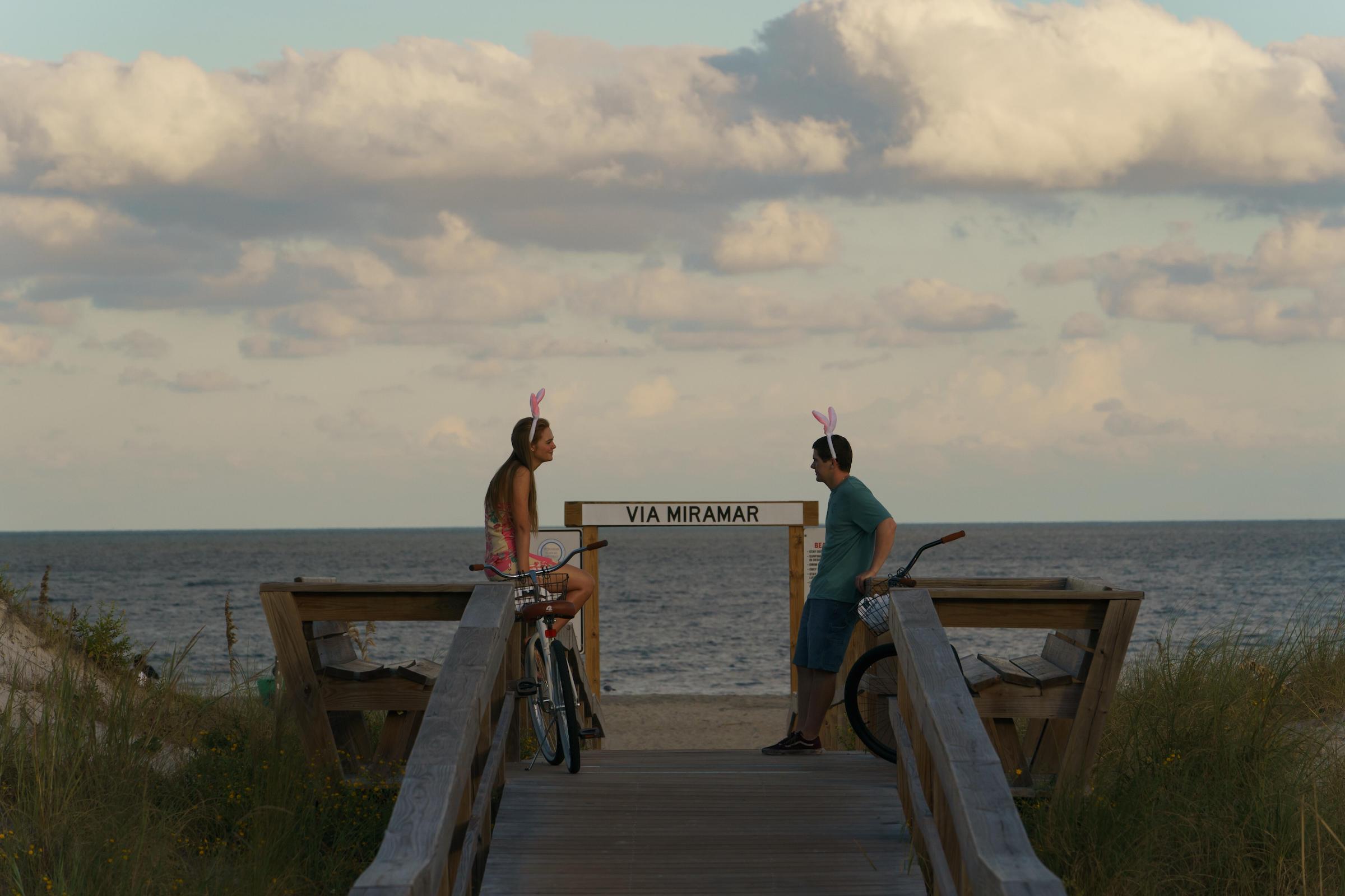 Michelle Carter talking to Conrad Roy at sunset on a bridge leading to the beach in 'The Girl From Plainville'