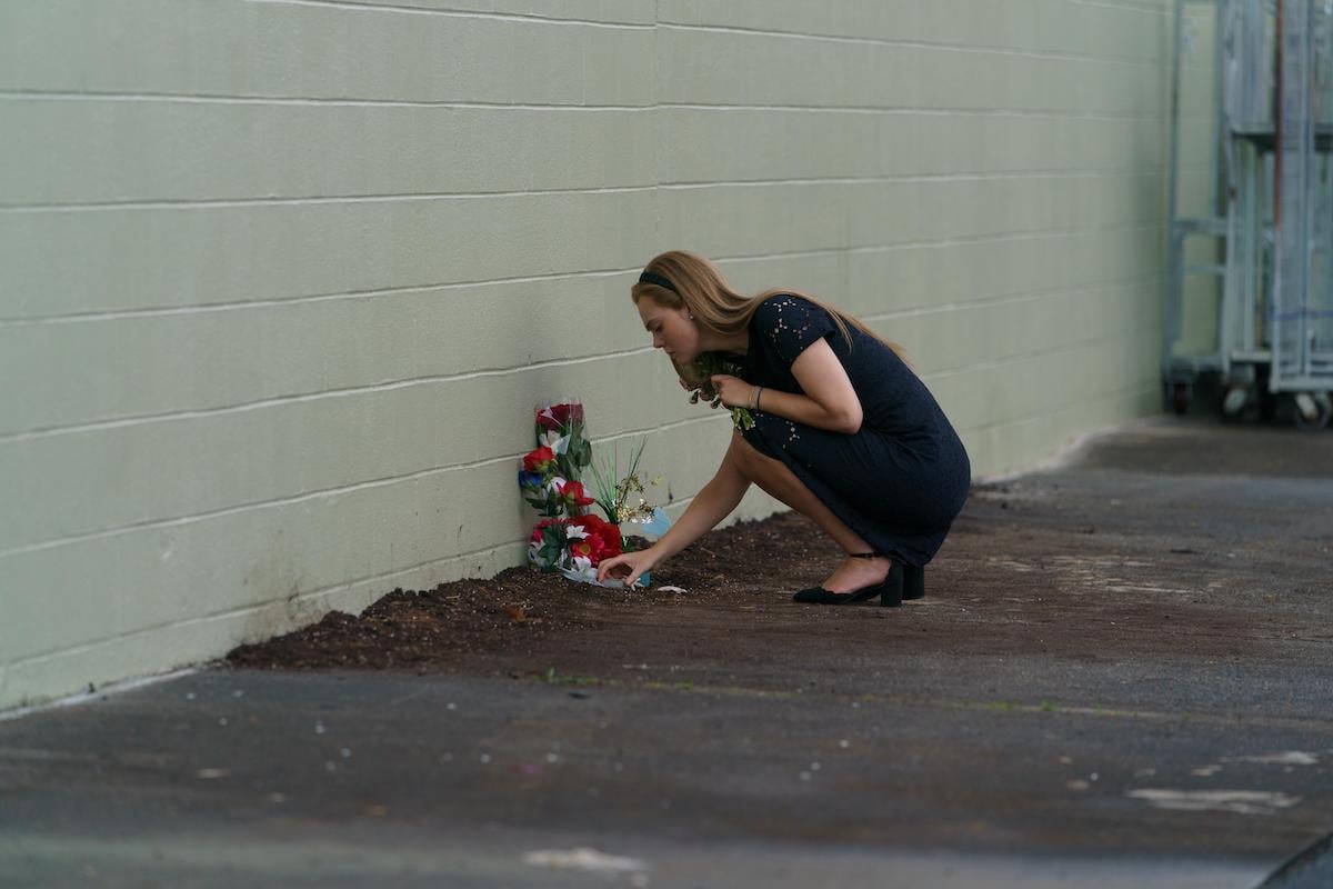 Elle Fanning as Michelle Carter putting flowers down where Conrad Roy died in 'The Girl From Plainville'