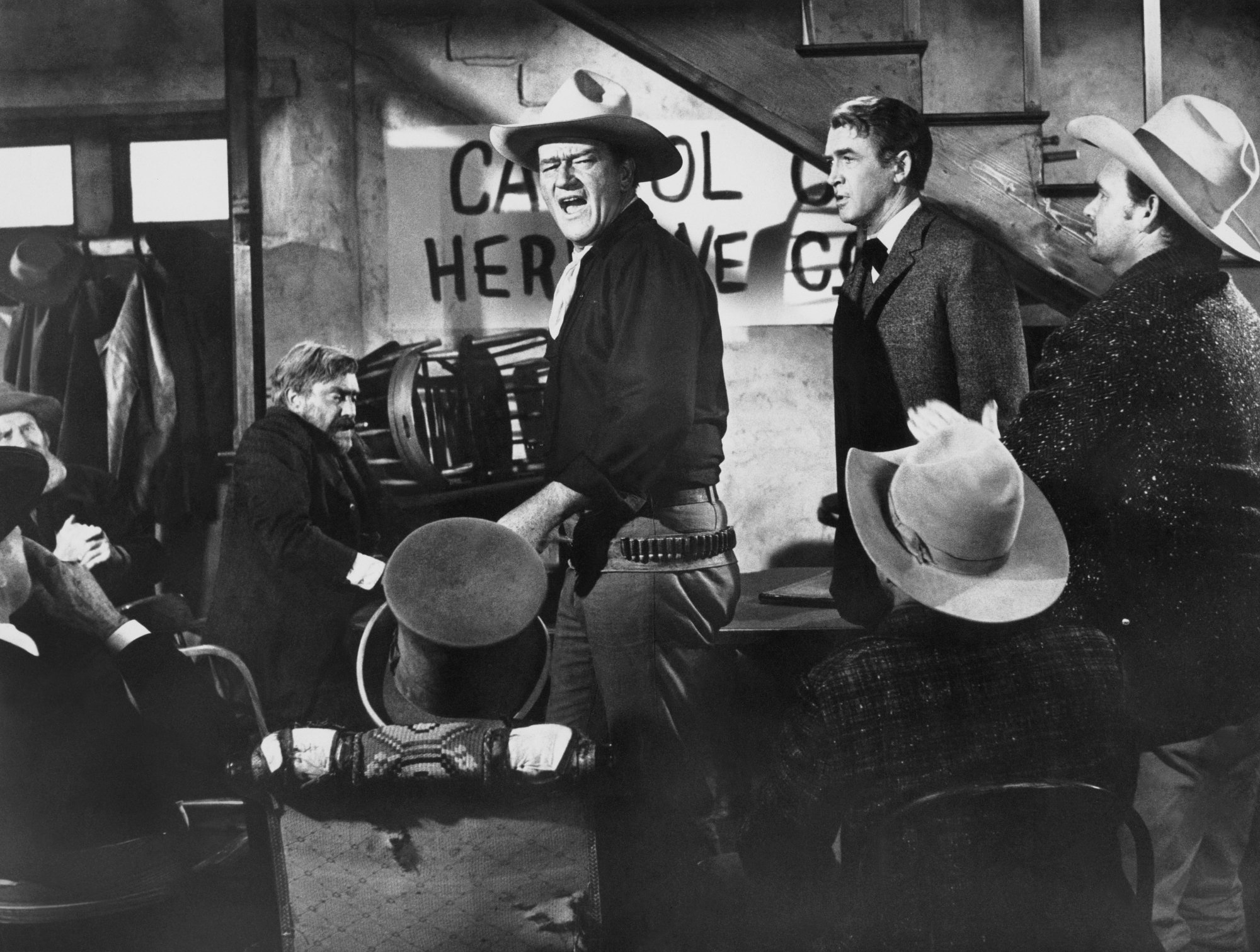 'The Man Who Shot Liberty Valance' John Wayne as Tom Doniphon and James Stewart as Ransom Stoddard shouting at assembly