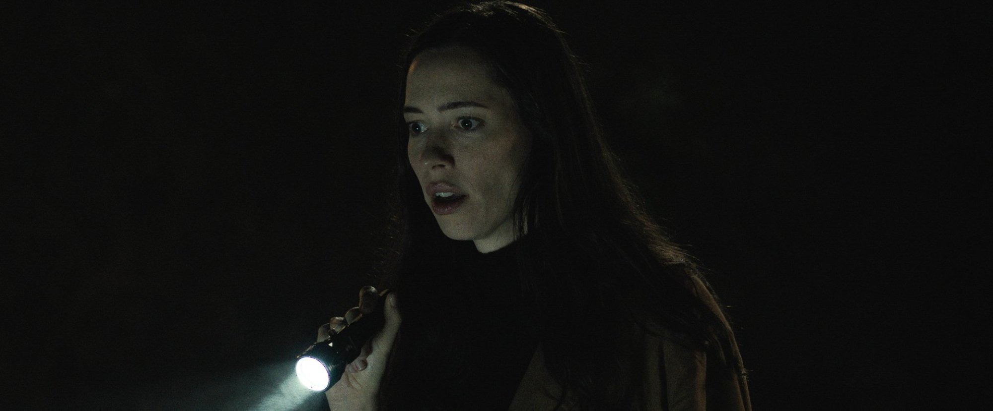 'The Night House' Rebecca Hall as Beth holding a flashlight in the dark