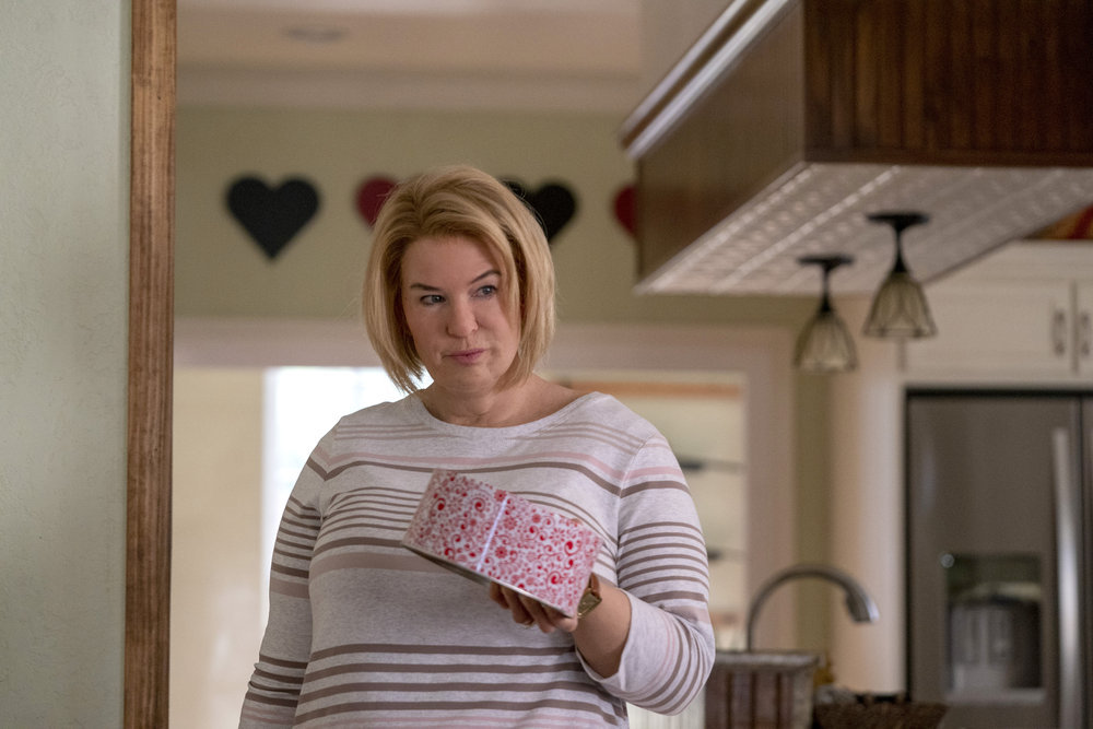 'The Thing About Pam' star Renée Zellweger holds a decorative tin in a production still from the limited series.