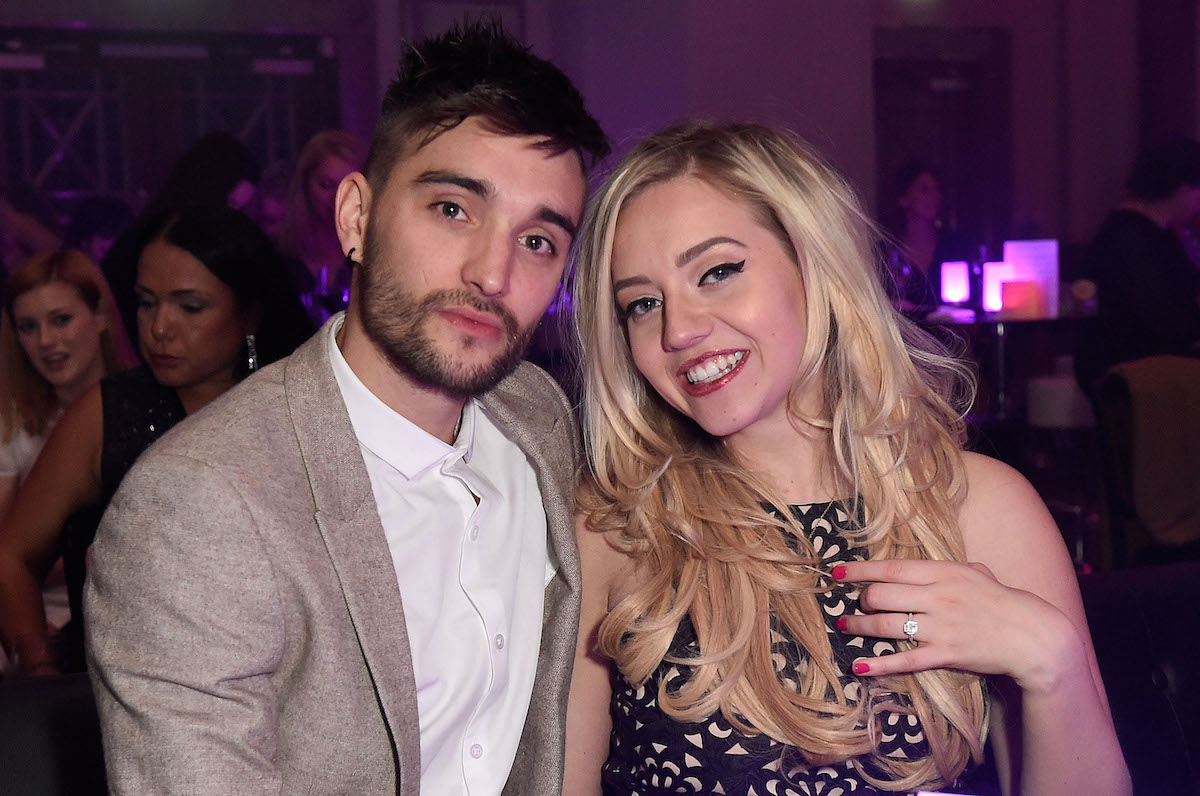 The Wanted's Tom Parker and Kelsey Parker smile as they sit next to each other