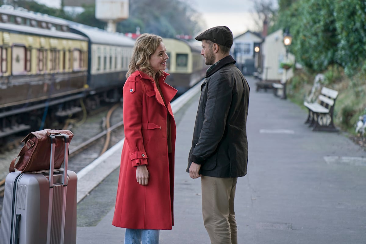 Eloise Mumford and Julian Morris standing on a train platform in 'The Presence of Love' 